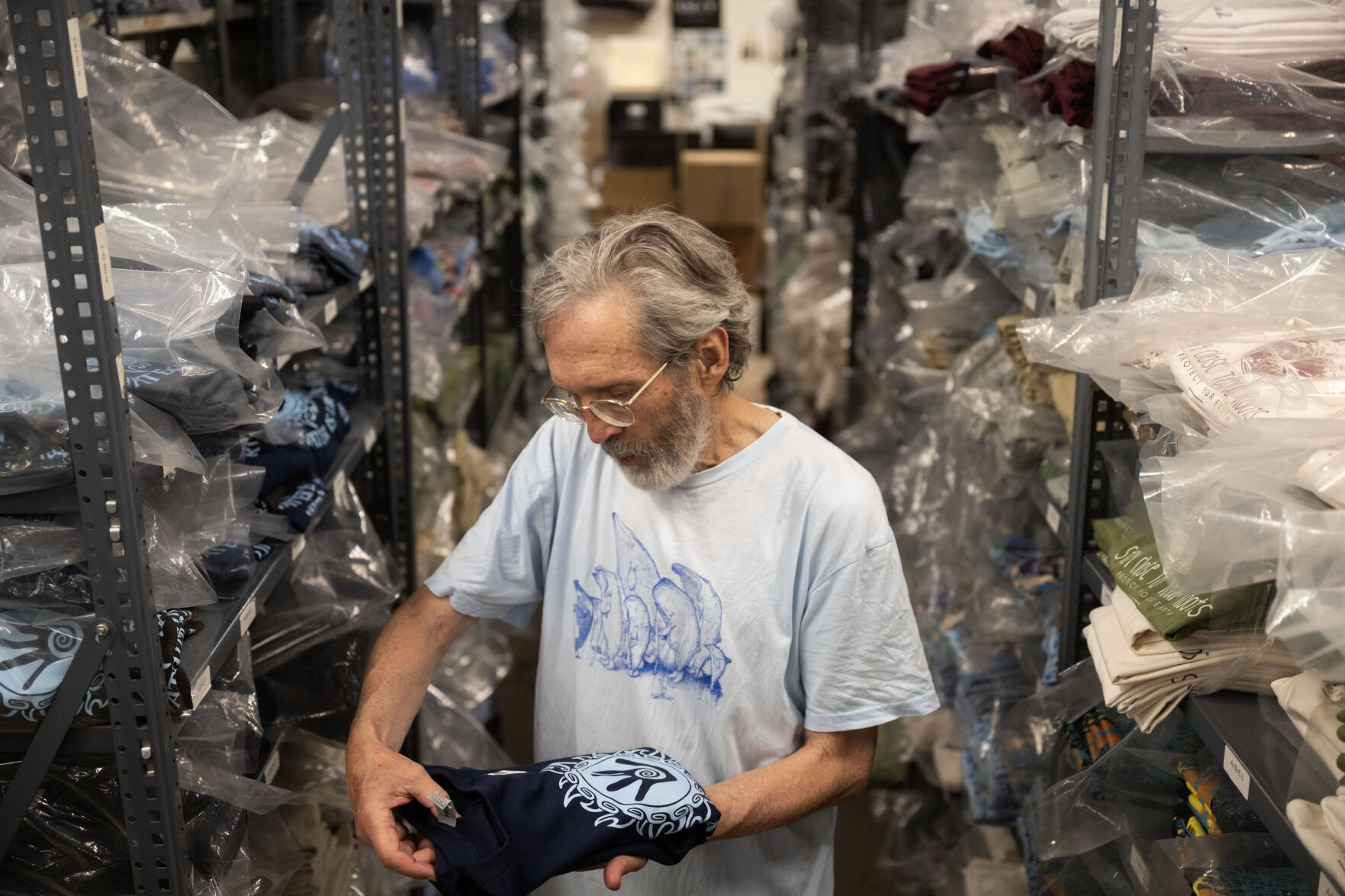 Jim Morris shows some of his favorite shirts at his shop in Boulder on Aug. 21. Morris has been running his environmental T-shirt company since 1976. (StephenSwoffordPhotographerstephen.swofford@gazette.comhttps://secure.gravatar.com/avatar/1ddcaf11c5d70eaa58546ddc4e038687?d=mm&r=g)