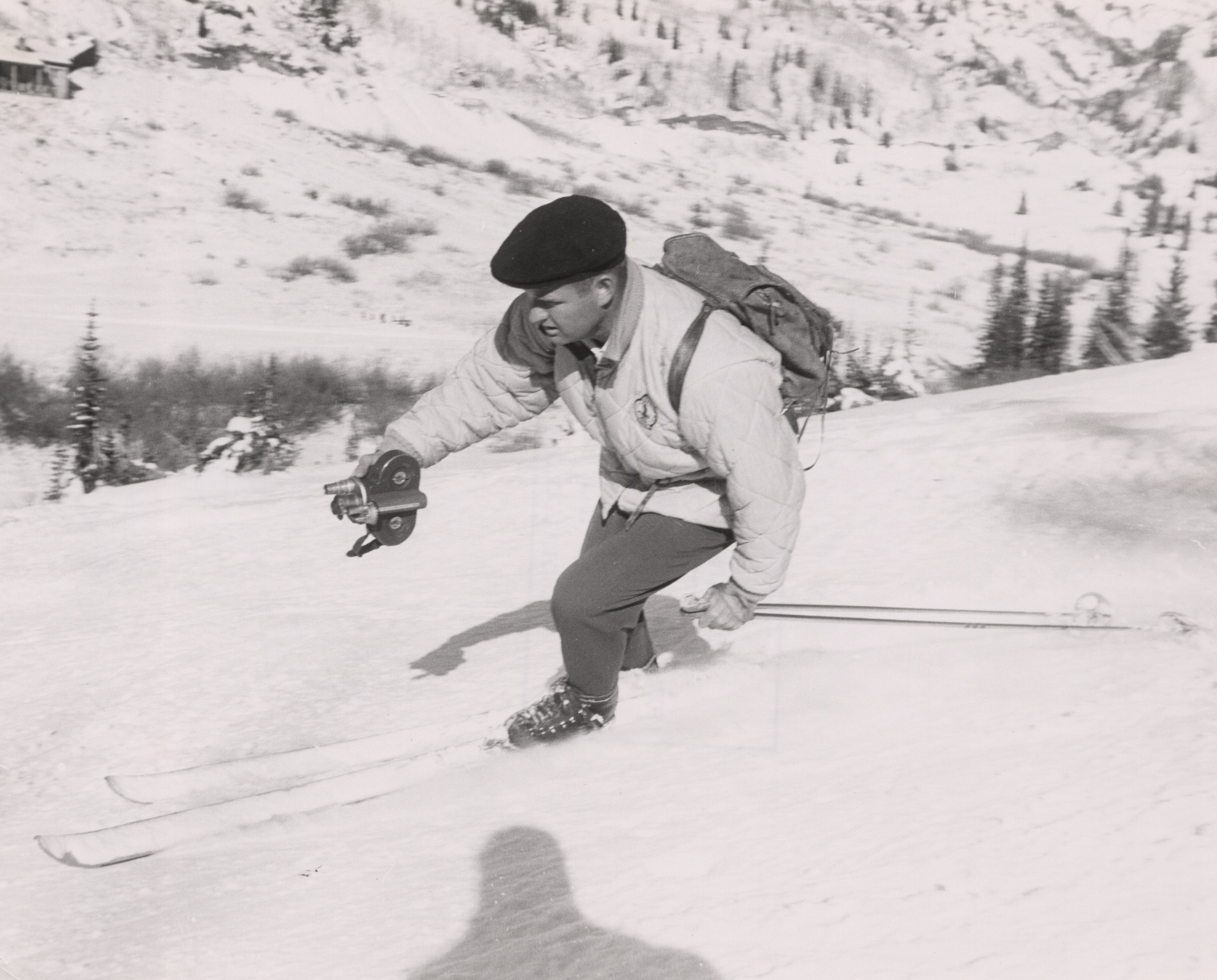 Warren Miller skiing with a film camera. (Courtesy, Warren Miller Entertainment)