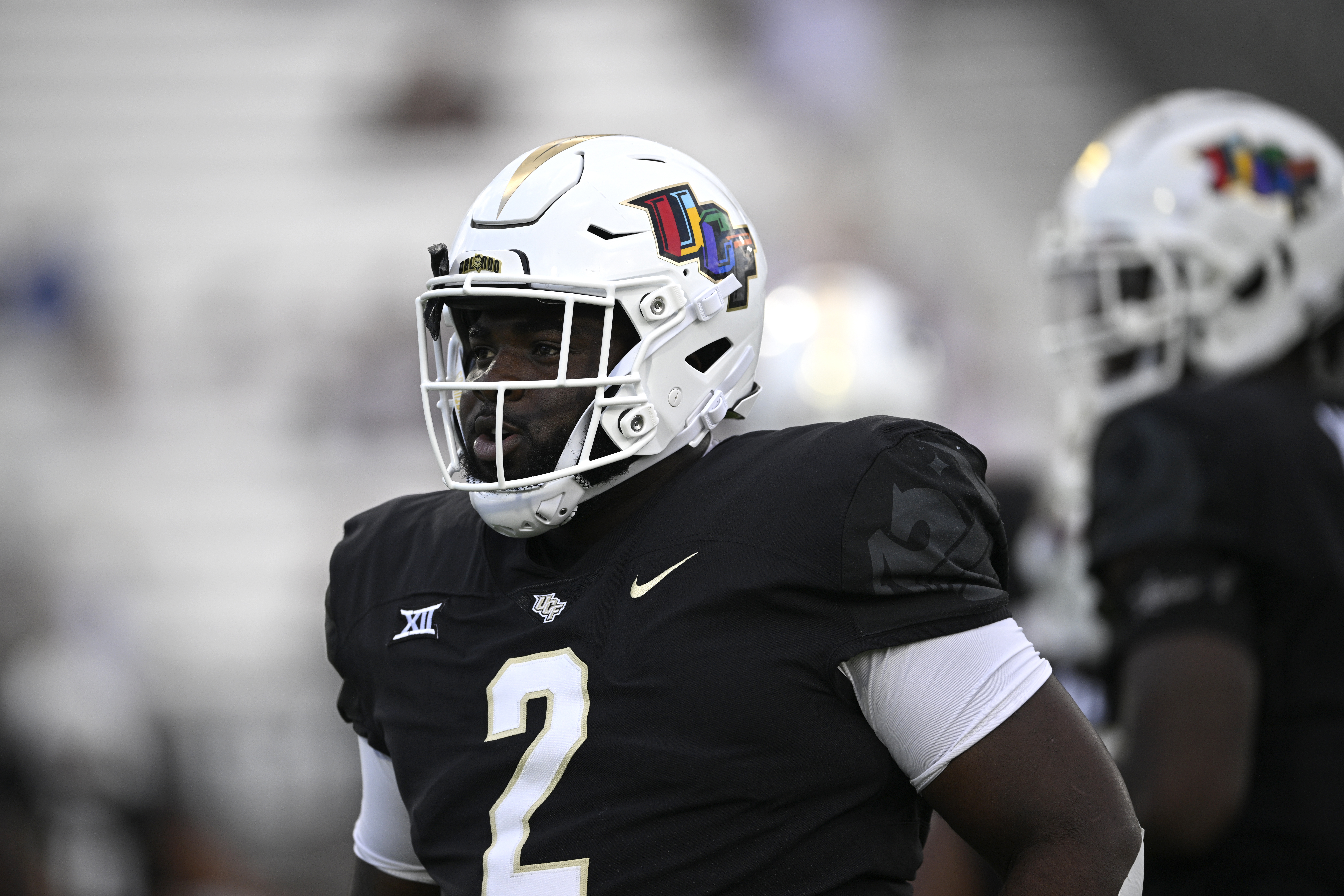 Central Florida defensive tackle Lee Hunter (2) displays a helmet decal designed by pediatric cancer patients in honor of Childhood Cancer Awareness Month while warming up before an NCAA college football game against Sam Houston State, Saturday, Sept. 7, 2024 in Orlando, Fla. (AP Photo/Phelan M. Ebenhack) (Phelan M. Ebenhack)