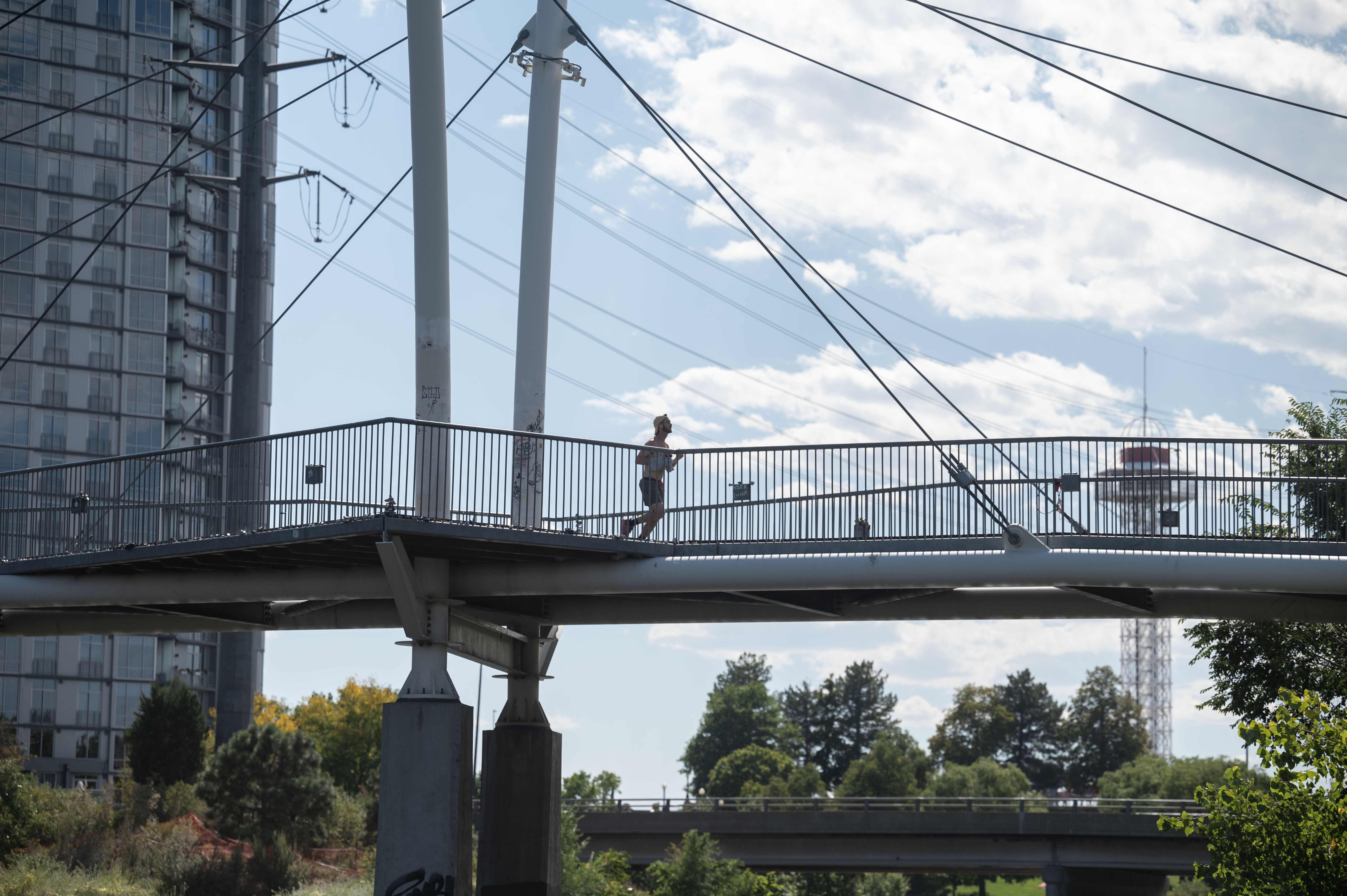 A man jogs across the Highland Cable Bridge at Commons Park in Denver on Thursday, Sept. 26, 2024. Denver's high temperature of 93 smashed a 14-year-old record. (Stephen Swofford, Denver Gazette) (StephenSwoffordPhotographerstephen.swofford@gazette.comhttps://secure.gravatar.com/avatar/1ddcaf11c5d70eaa58546ddc4e038687?d=mm&r=g)