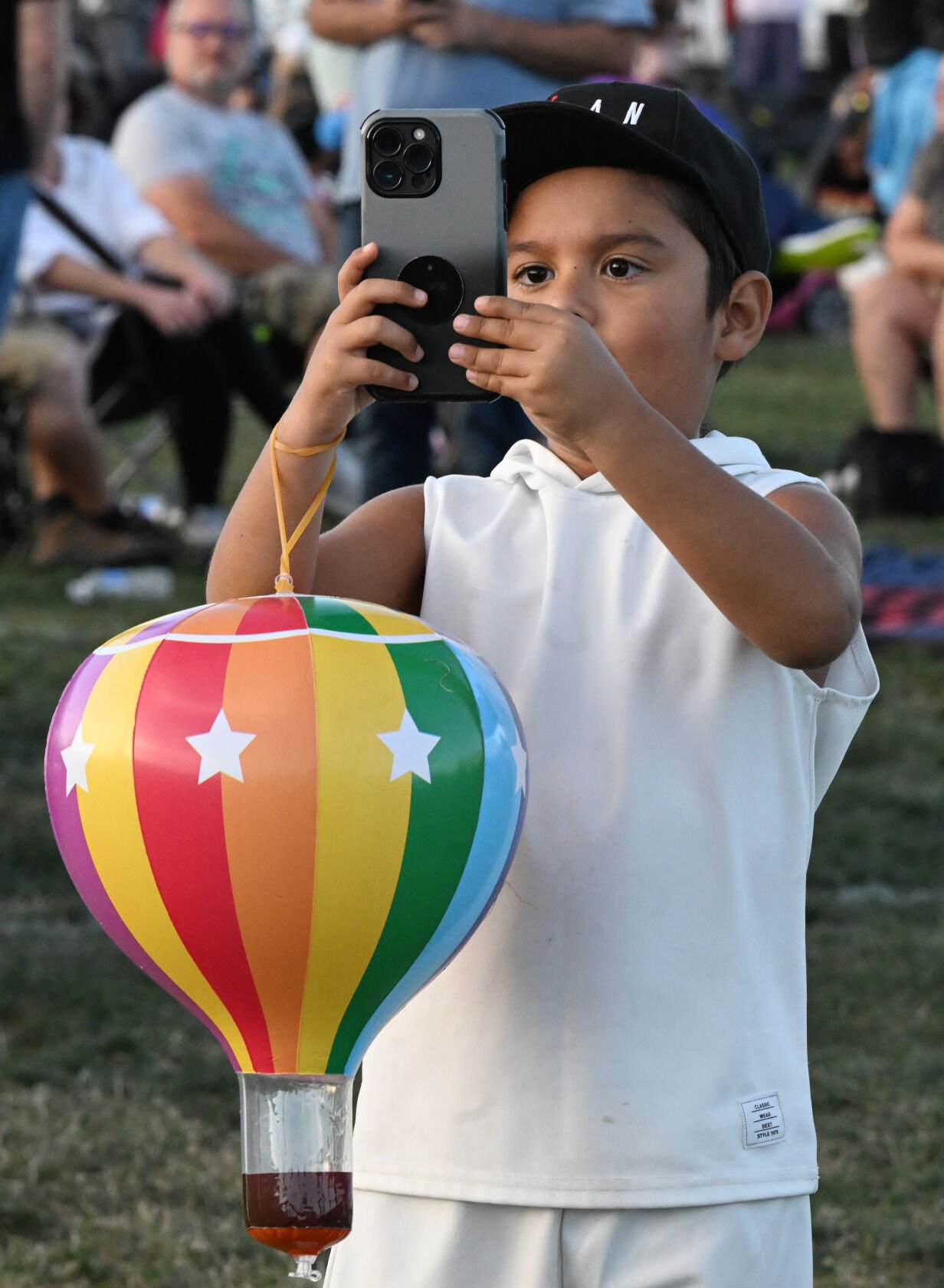 A young photographer captures images during the balloon glow of the Colorado Springs Labor Day Lift Off on Sunday, Sept. 1, 2024.