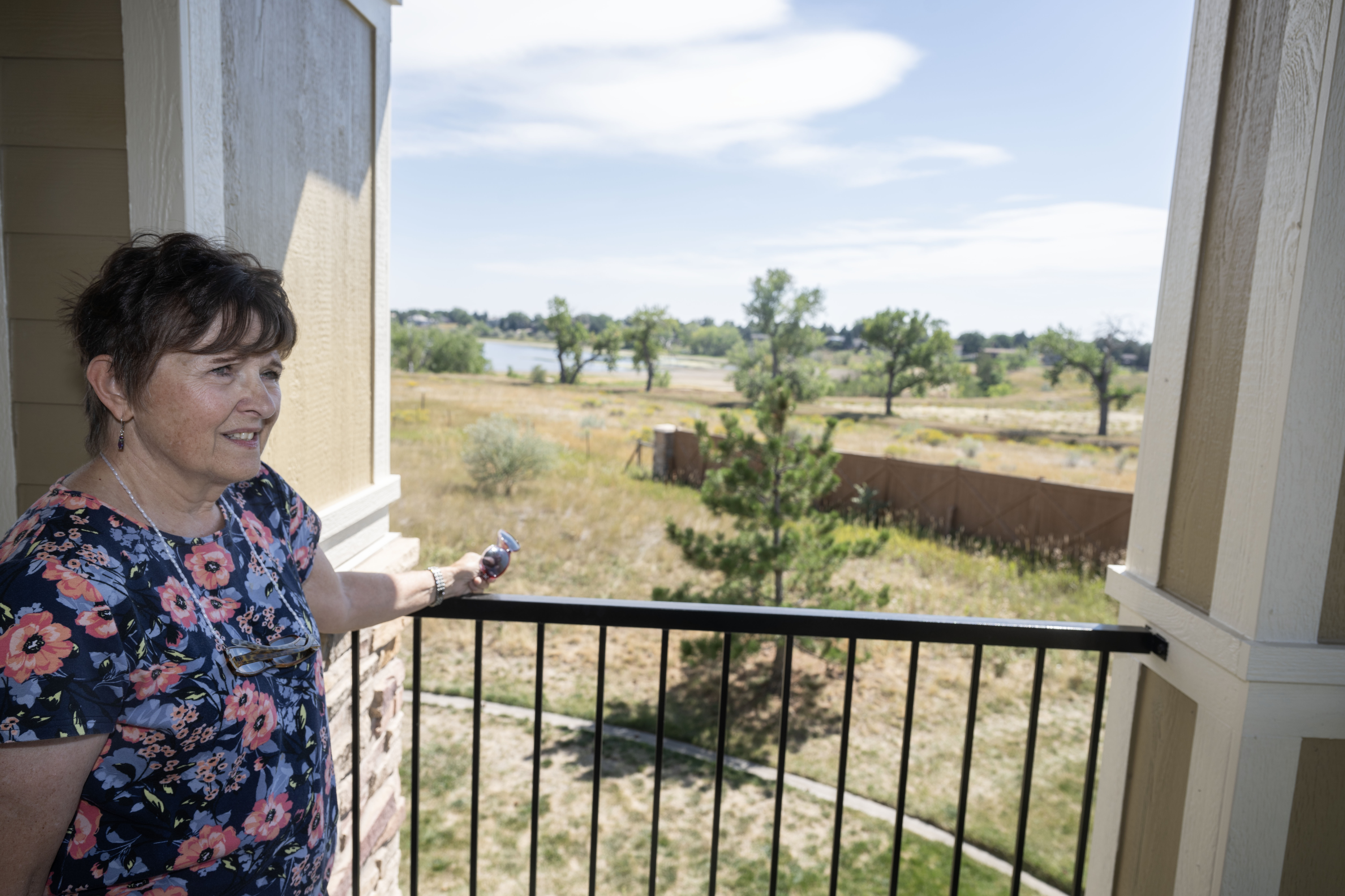 Lynn Clemens looks out over a view from Judy Farley’s balcony while discussing a year-long fight to push for a moratorium on a 500,000 square-foot warehouse development at 60th and McIntyre on Thursday, Sept. 12, 2024. (Stephen Swofford, Denver Gazette) (Stephen Swofford Denver Gazette)