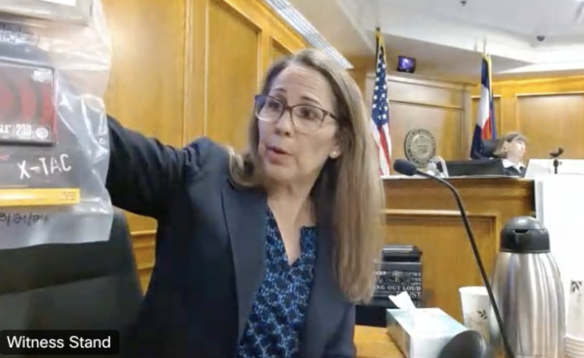 FBI Special Agent Stephanie Benitez showed the jury in the Boulder mass shooting trial a plastic-wrapped package which contains three empty ammunition boxes which investigators found in the alleged gunman's bedroom closet in the early hours of March 23, 2021, after the incident. Investigators also found an AR pistol, multiple loaded magazines, receipts for firearms and potential bomb-making materials. (Screengrab of 20th Judicial District WebEx live feed)
