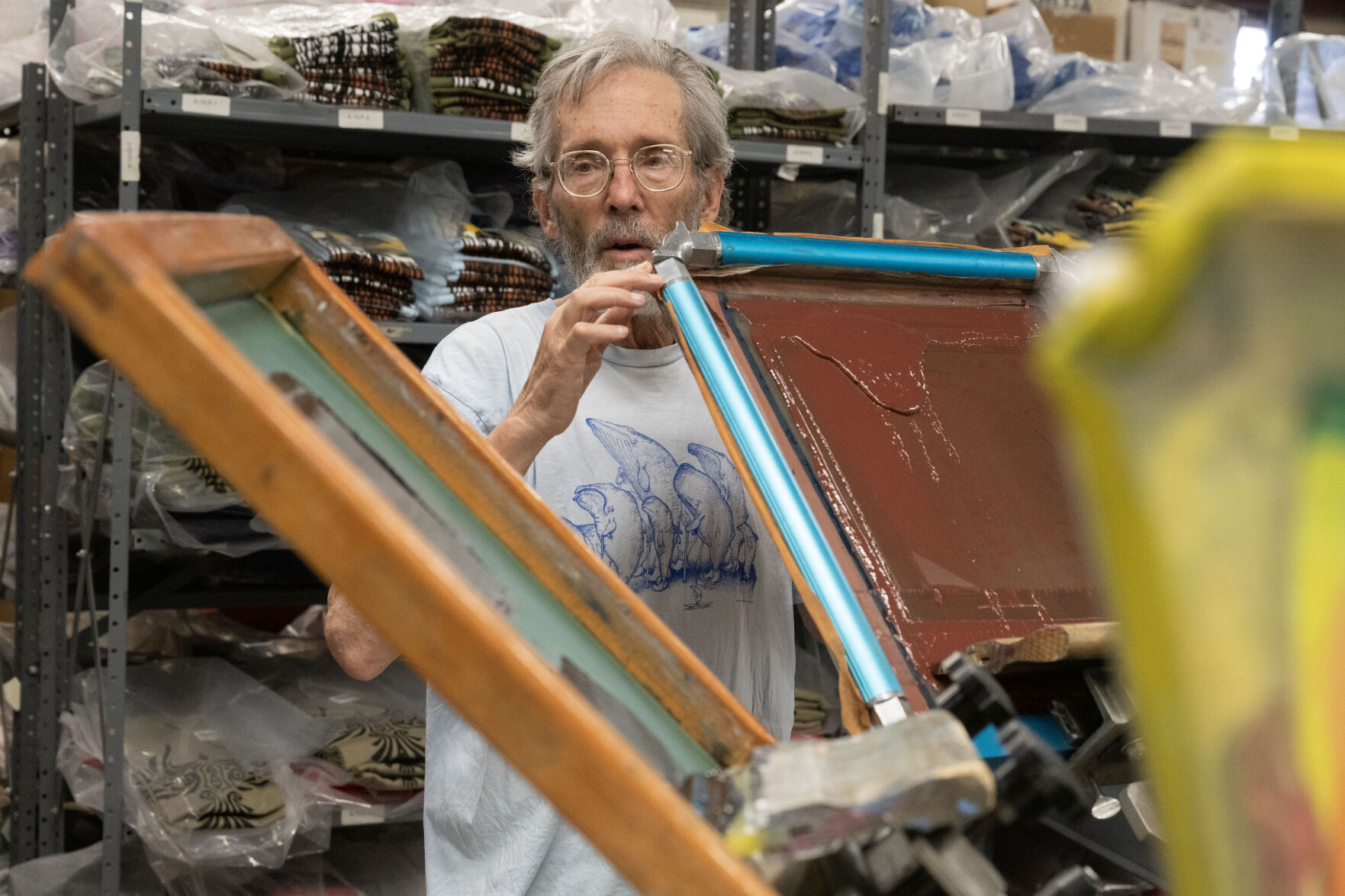 Jim Morris shows his screen printing machine during a tour of his company on Wednesday, Aug. 21, 2024. Morris has been running his environmental t-shirt company since 1976. (Stephen Swofford, Denver Gazette) (StephenSwoffordPhotographerstephen.swofford@gazette.comhttps://secure.gravatar.com/avatar/1ddcaf11c5d70eaa58546ddc4e038687?d=mm&r=g)