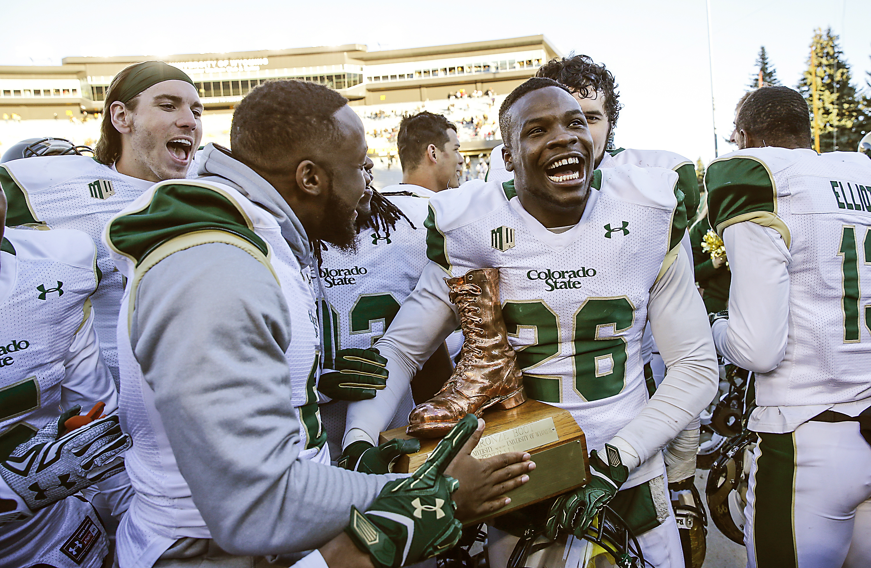 Colorado State's Kevin Pierre-Louis (26) celebrates with the Bronze Boot trophy after an NCAA college football game against Wyoming, Saturday, Nov. 7, 2015, in Laramie, Wyo. Colorado State defeated Wyoming 26-7. (AP Photo/Michael Smith) (Michael Smith)