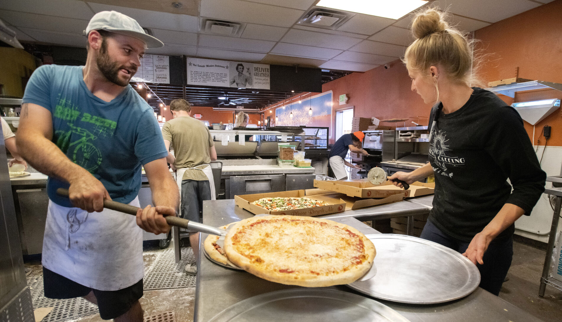 James “Jimbo” Webb, left, and Madison Tomlinson work in the busy kitchen at The Hot Tomato in Fruita, Colo., Tuesday, May 10, 2022. (The Gazette, Christian Murdock) (Christian Murdock/The Gazette)