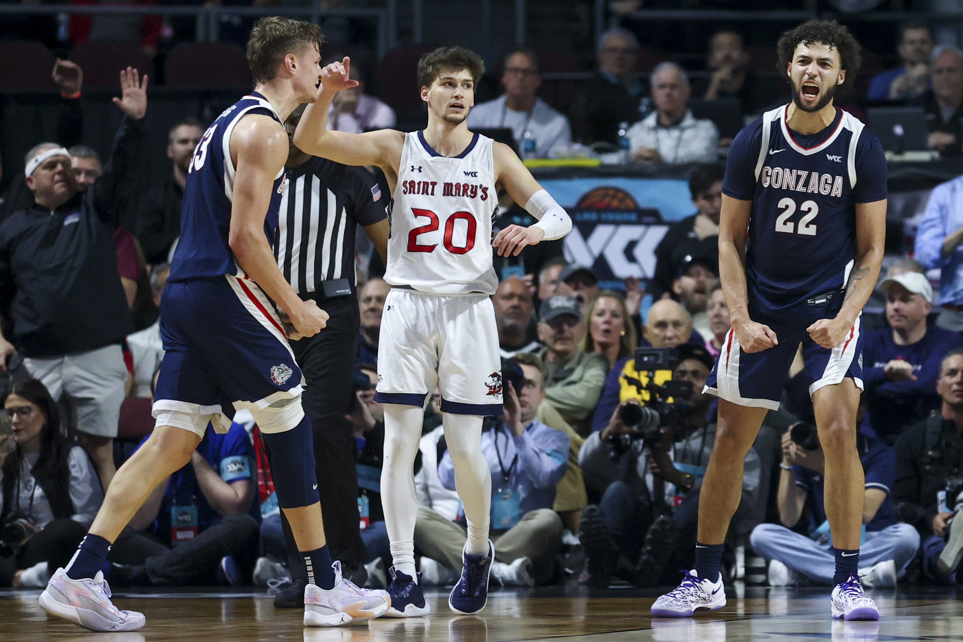 Gonzaga forwards Ben Gregg (33) and Anton Watson (22) celebrate near Saint Mary's guard Aidan Mahaney (20) during the second half of an NCAA college basketball game for the championship of the West Coast Conference men's tournament Tuesday, March 12, 2024, in Las Vegas. (AP Photo/Ian Maule) (Ian Maule)