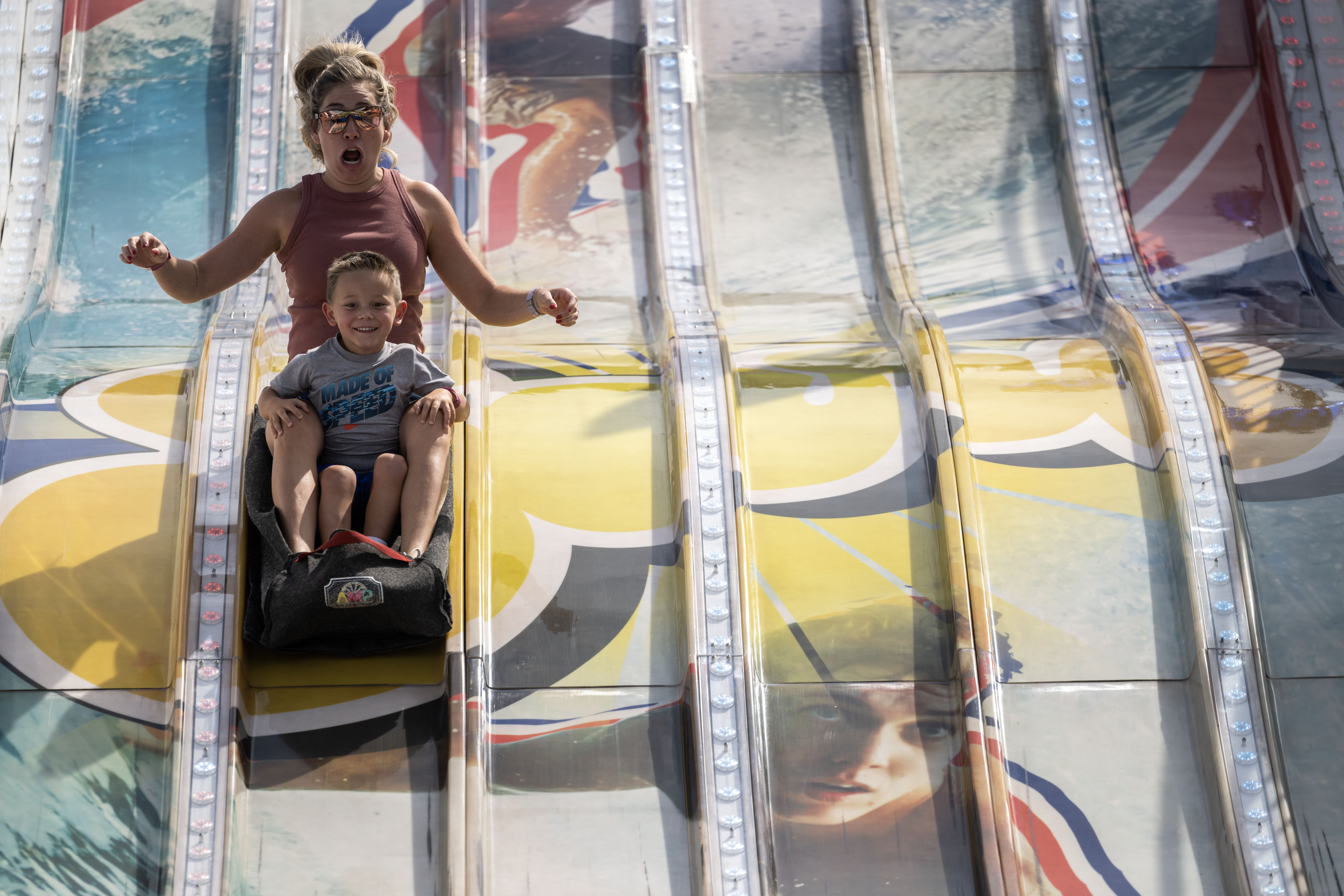 Lacy Davidson rides the big Surf slide with her son, Bo, 3, at the Colorado State Fair on Wednesday, Aug. 28, 2024 (Stephen Swofford, Denver Gazette) (StephenSwoffordPhotographerstephen.swofford@gazette.comhttps://secure.gravatar.com/avatar/1ddcaf11c5d70eaa58546ddc4e038687?d=mm&r=g)