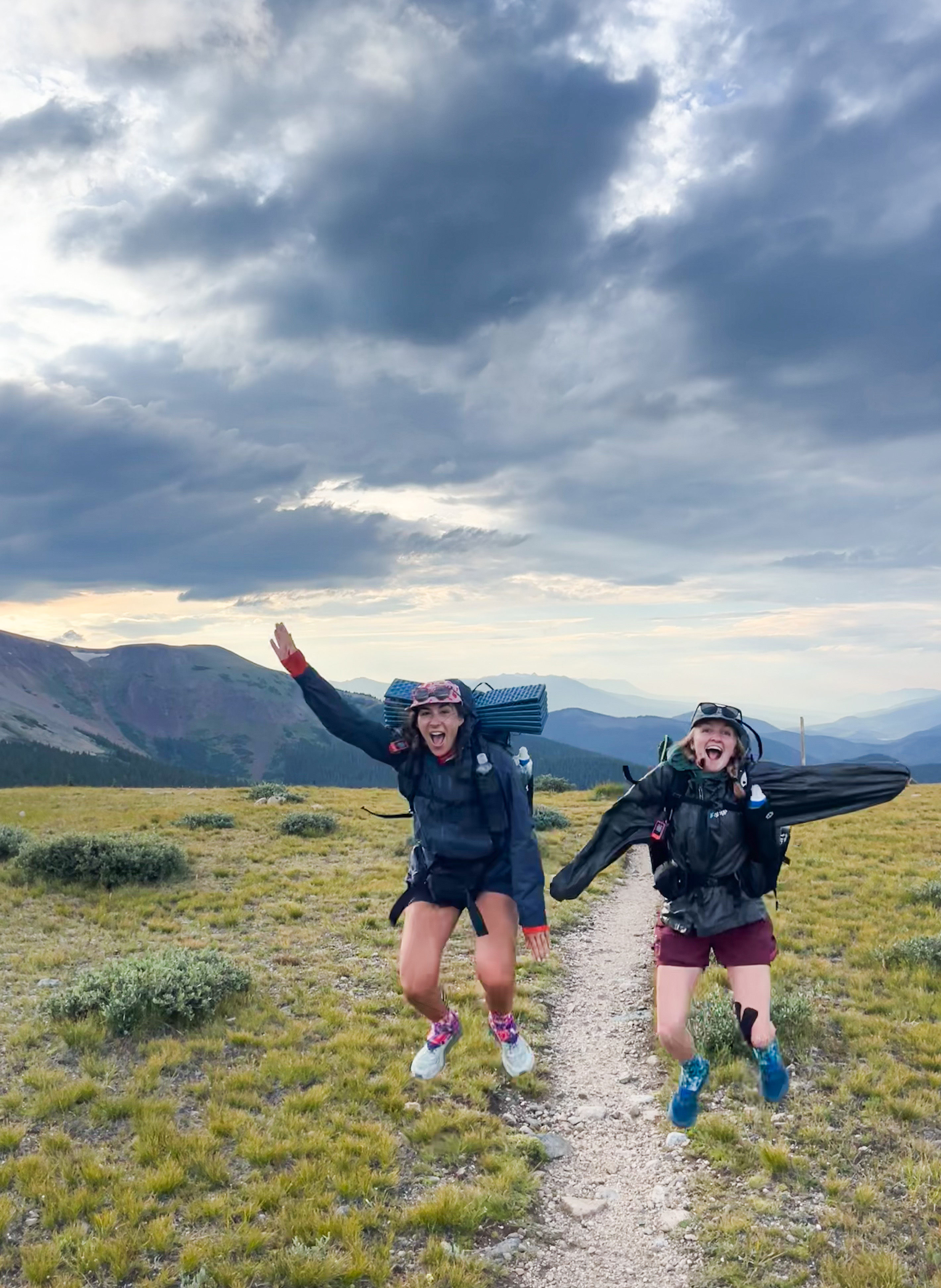 Ariella Nardizzi and Kyla Pearce jump for a photo atop Georgia Pass on the Colorado Trail on Aug. 8. (Hilde Ringger, Special to The Gazette)
