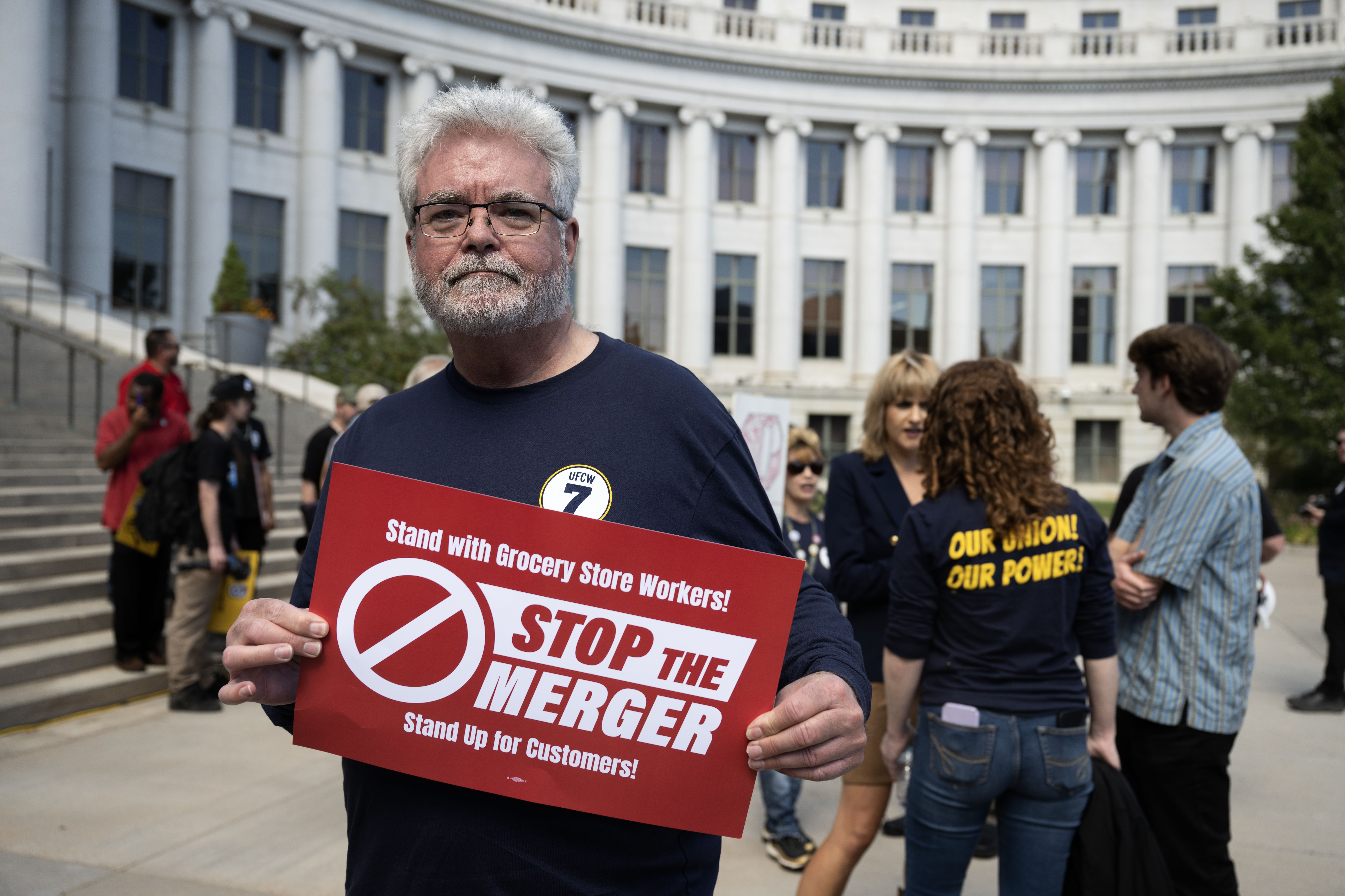 John R Young, a member of the United Food and Commercial Workers International Union Local 7, holds a sign a rally calling for a stop to the merger between Kroger and Albertsons outside the Denver City and County Building on Monday, Sept. 30, 2024 (Stephen Swofford, Denver Gazette) (StephenSwoffordPhotographerstephen.swofford@gazette.comhttps://secure.gravatar.com/avatar/1ddcaf11c5d70eaa58546ddc4e038687?d=mm&r=g)