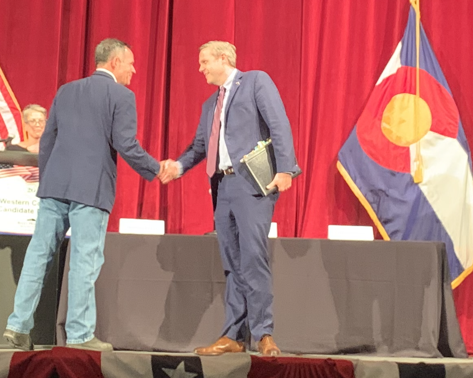 Major party candidates for Congressional District 3 shake hands before taking off the gloves for the CD 3 debate at Club 20's Sept. 21 debate day event. Adam Frisch (D) shakes hands with Jeff Hurd (R). Moderator Edie Sonn is at the left. (MarianneGoodlandmarianne.goodland@coloradopolitics.comhttps://secure.gravatar.com/avatar/125a14b7bd9266f61a445ec13b1d3605?d=mm&r=g)