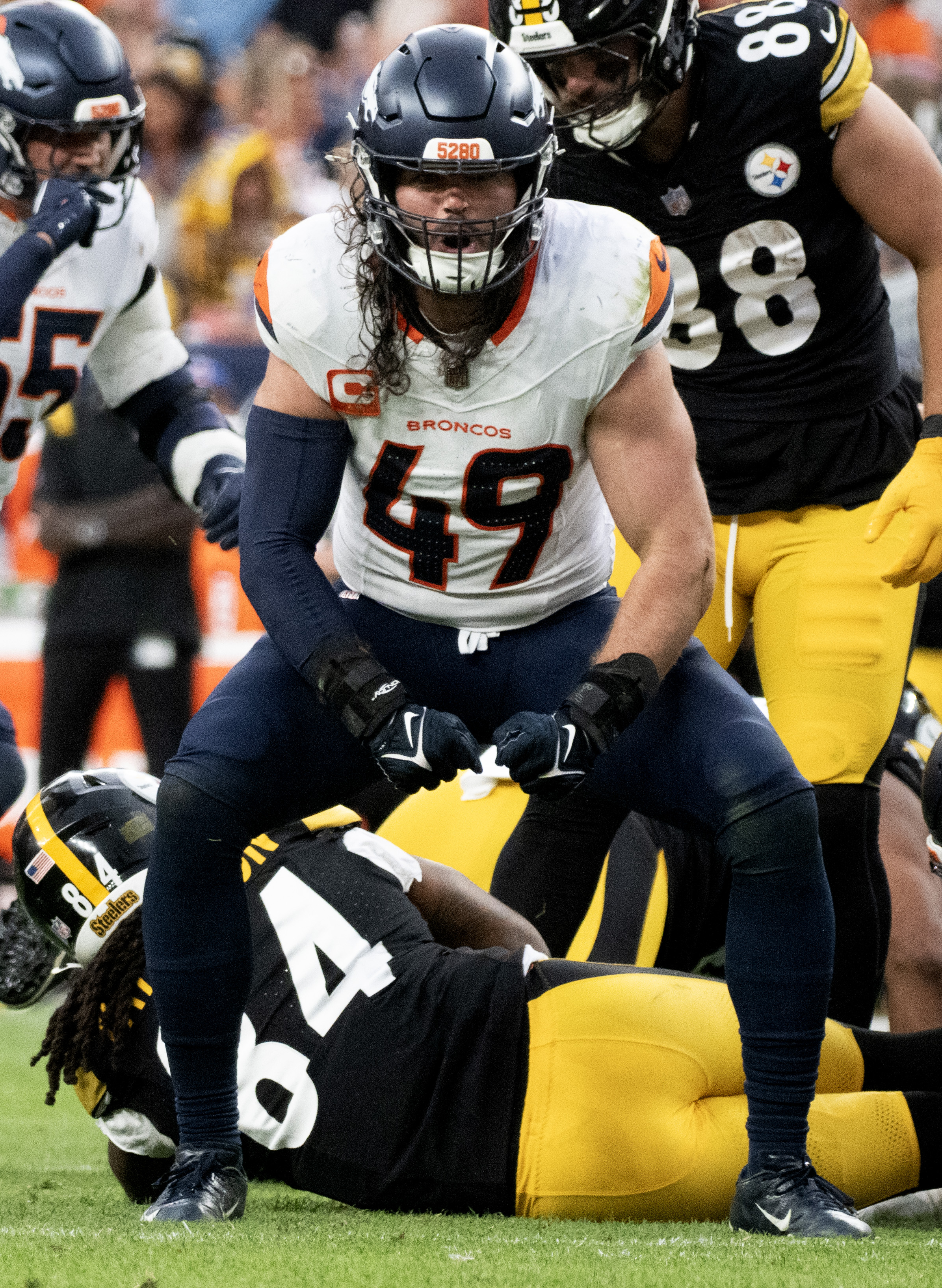 Denver Broncos linebacker Alex Singleton (49) celebrates after stopping Pittsburgh Steelers running back Cordarrelle Patterson (84) for a short gain during the second half Sunday, Sept. 15, 2024, at Empower Field at Mile High in Denver. Pittsburgh won 13-6. (The Gazette, Christian Murdock) (Christian Murdock)