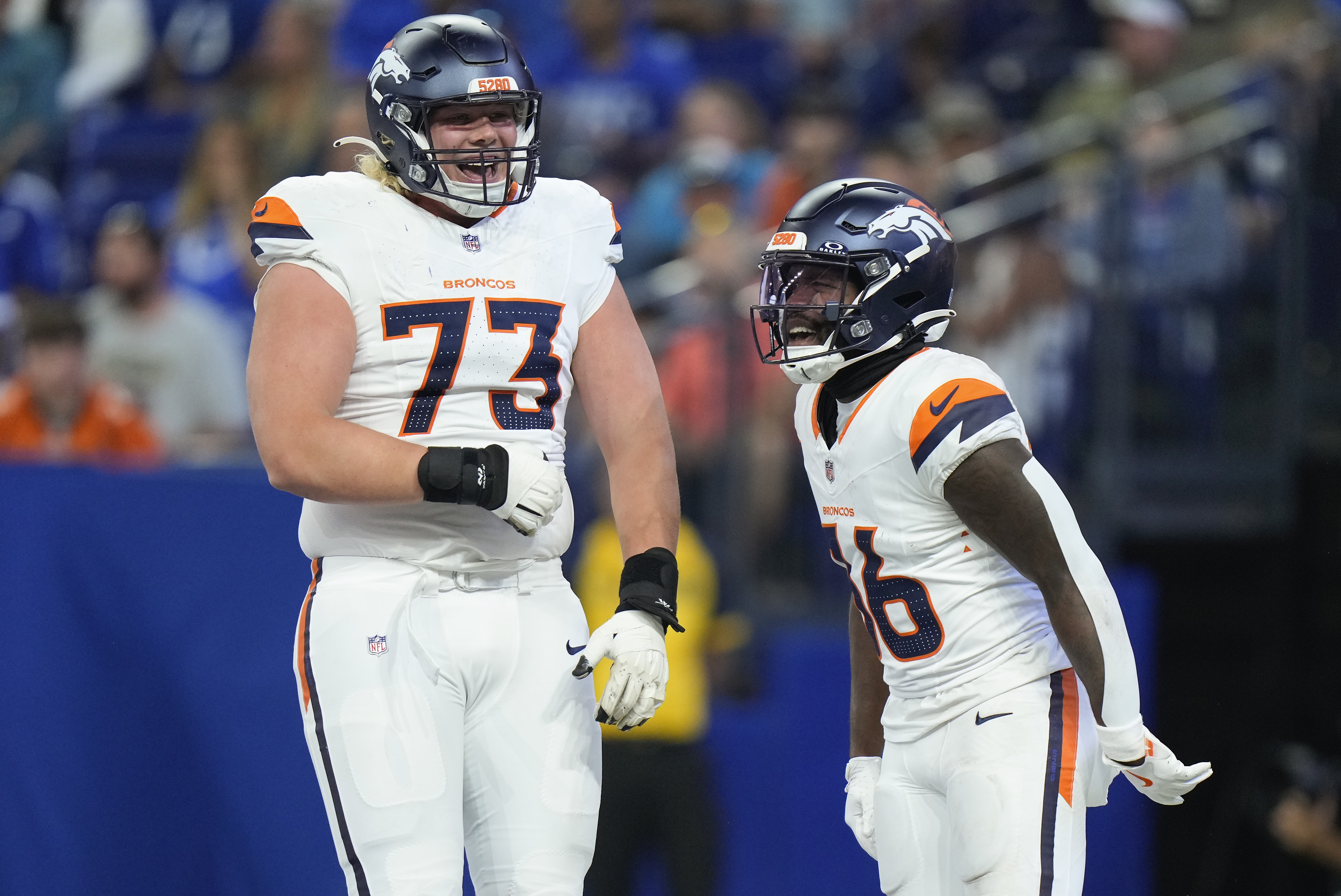 Denver Broncos running back Tyler Badie (36) celebrates with Denver Broncos offensive tackle Frank Crum (73) after scoring a touchdown against the Indianapolis Colts during the third quarter of a preseason NFL football game, Sunday, Aug. 11, 2024, in Westfield, Ind. (AP Photo/AJ Mast) (AJ Mast)
