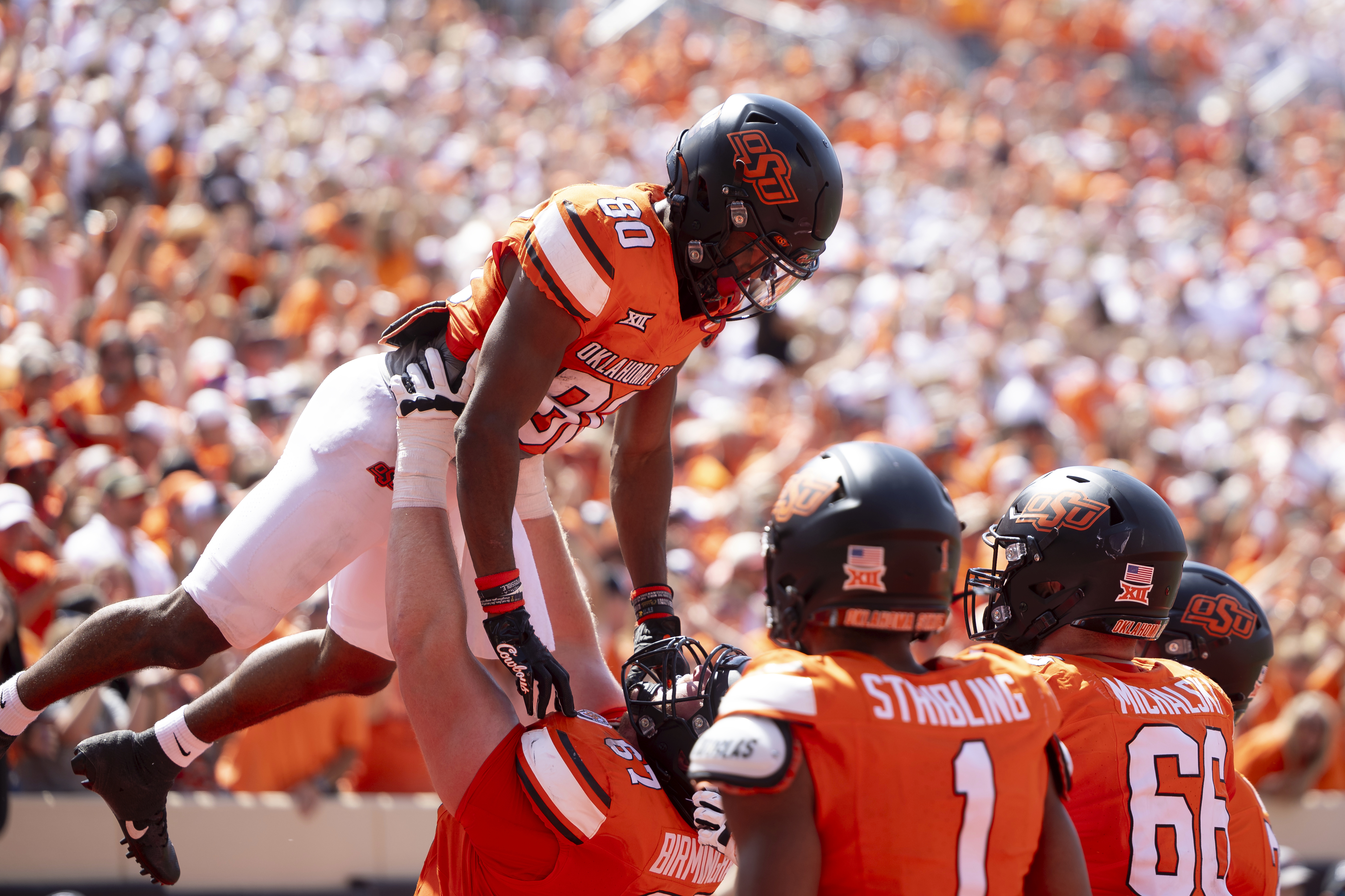 Oklahoma State wide receiver Brennan Presley (80) celebrates with teammates in the end zone in the second half of an NCAA college football game against Arkansas Saturday, Sept. 7, 2024, in Stillwater, Okla. (AP Photo/Mitch Alcala) (Mitch Alcala)