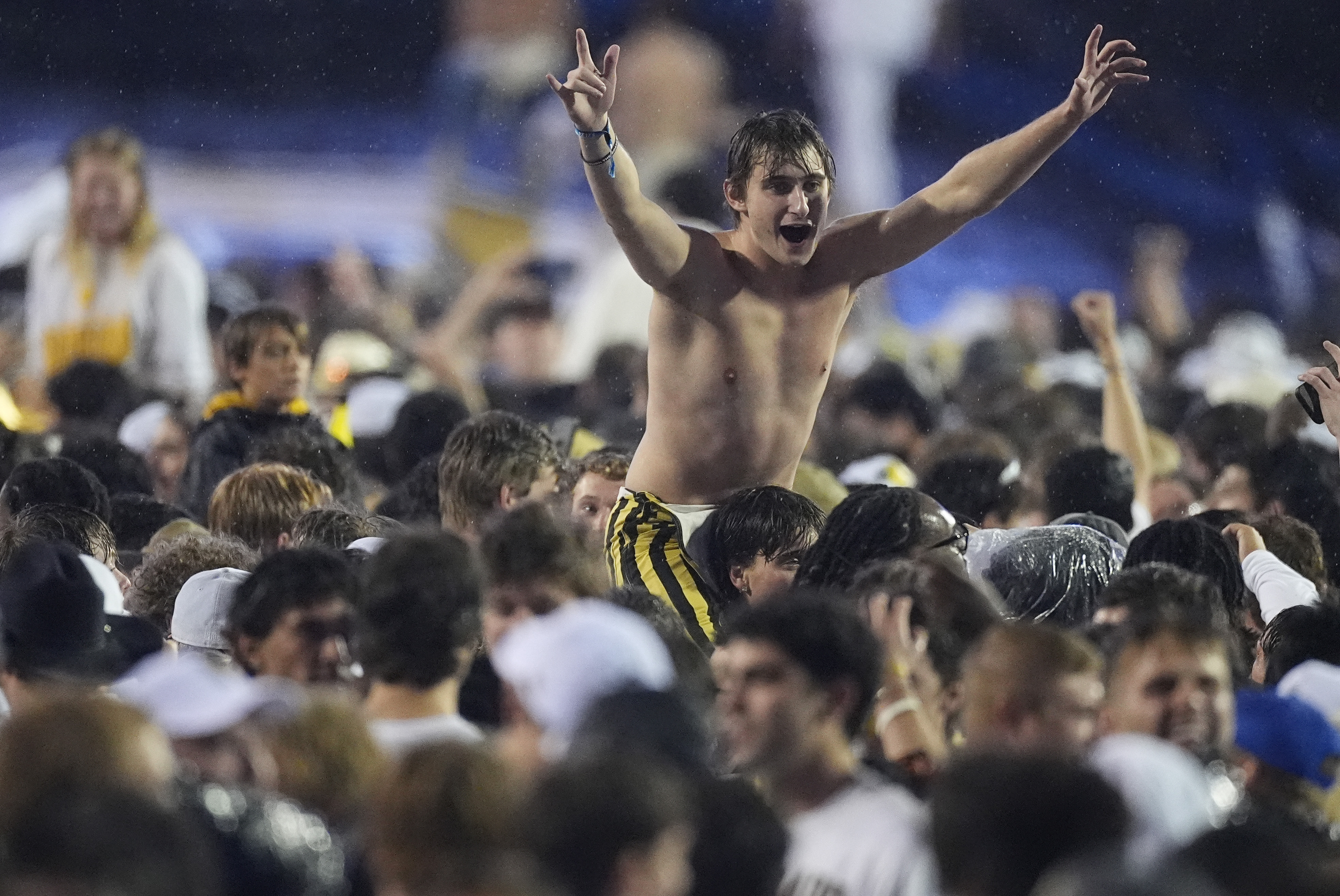 Colorado fans storm the field to celebrate after Colorado's overtime victory over Baylor in an NCAA college football game Saturday, Sept. 21, 2024, in Boulder, Colo. (AP Photo/David Zalubowski) (David Zalubowski)