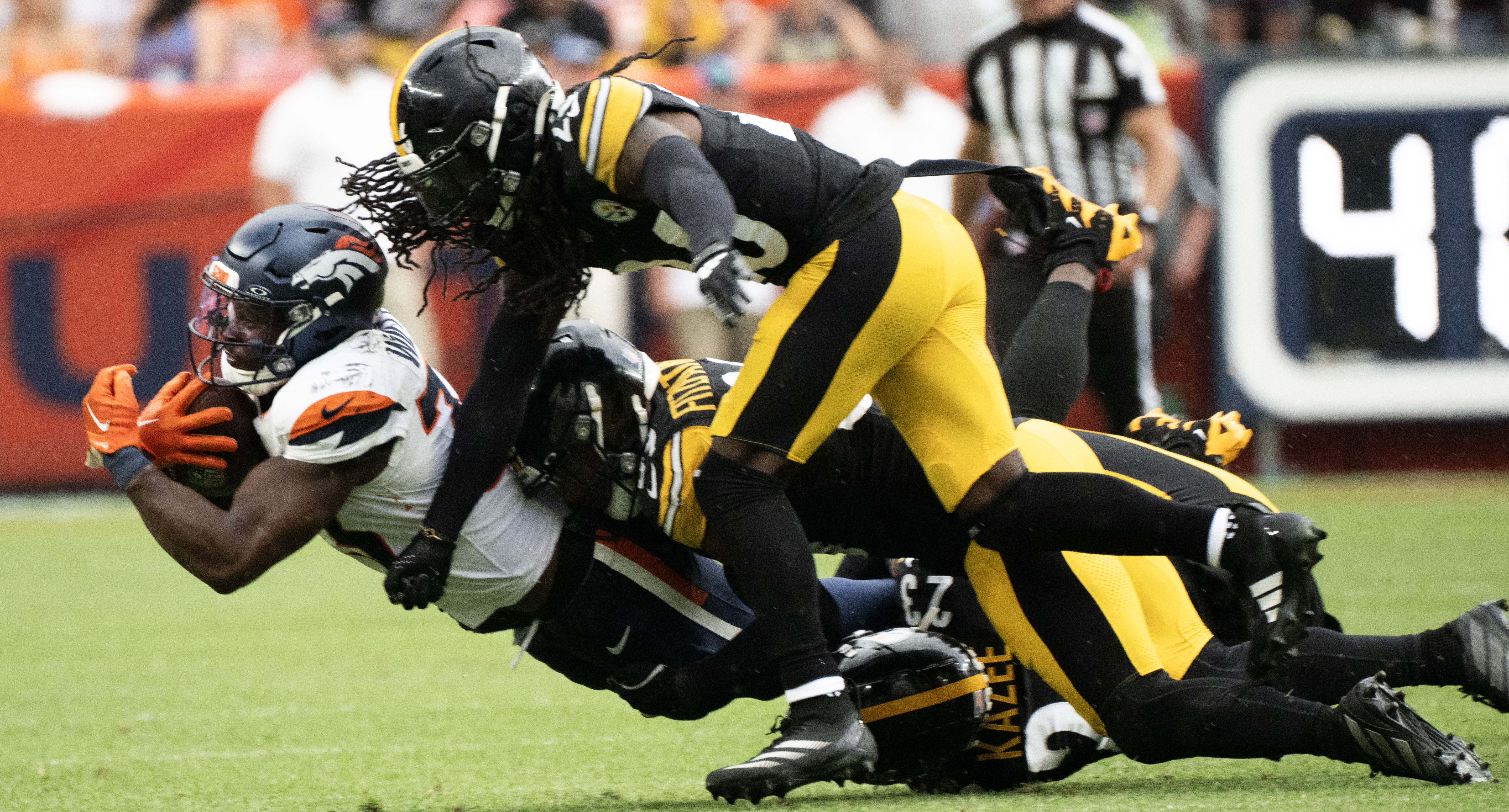 Pittsburgh Steelers cornerback Donte Jackson (26) and safety Minkah Fitzpatrick (39) bring down Denver Broncos running back Javonte Williams (33) during the second half Sunday, Sept. 15, 2024, at Empower Field at Mile High in Denver. Pittsburgh won 13-6. (The Gazette, Christian Murdock) (Christian Murdock)