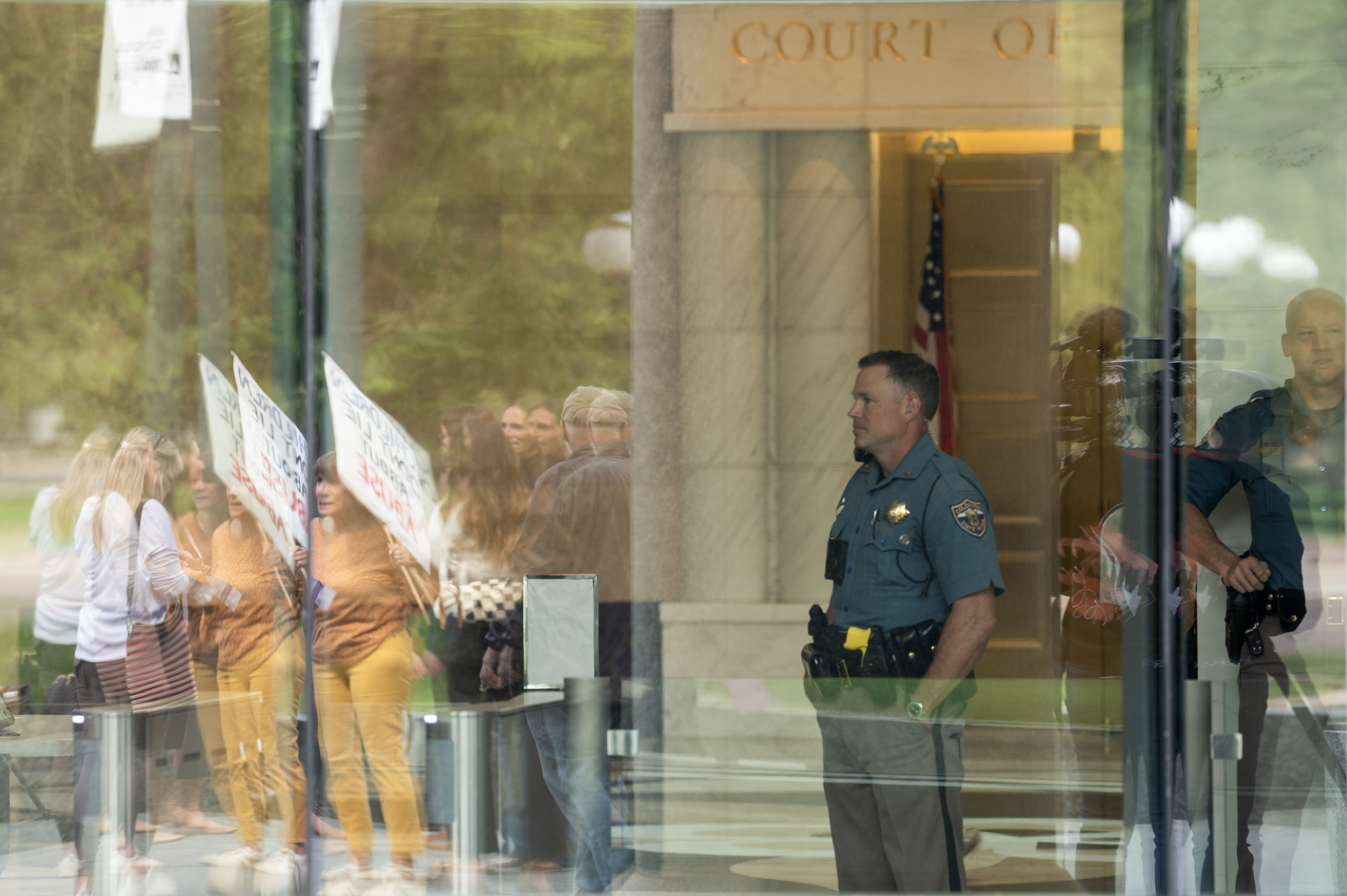 Security officers watch through the front windows of the Ralph L. Carr Colorado Justice Center in Denver during a rally calling for family court reforms on Thursday, Sept. 5, 2024. (Stephen Swofford, Denver Gazette) (Stephen Swofford Denver Gazette)