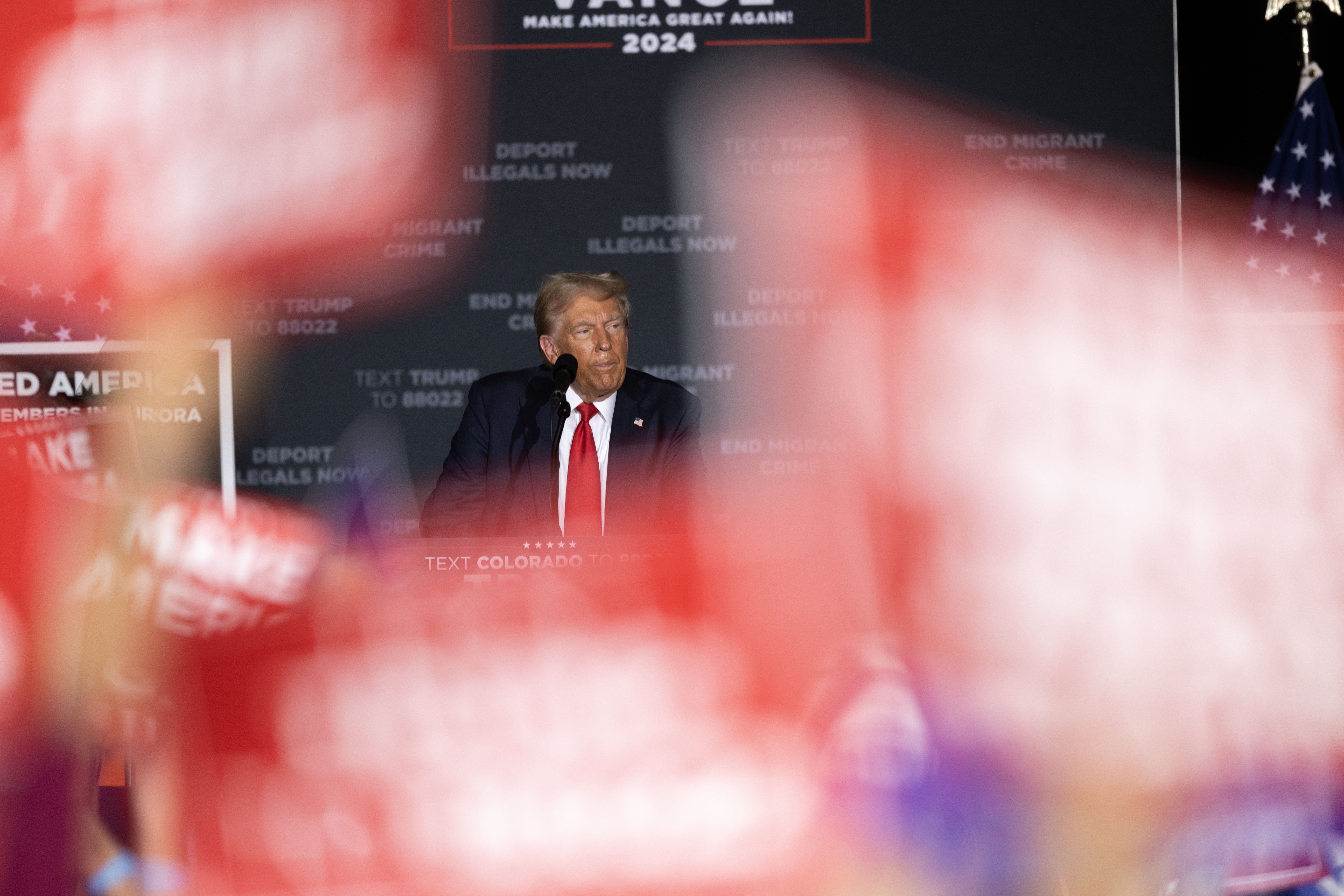 Trump pauses for applause and cheers as he discusses immigration during a political rally at the Gaylord Rockies Resort and Convention Center in Aurora on Friday, Oct. 11, 2024. (Stephen Swofford, Denver Gazette) (Stephen Swofford Denver Gazette)
