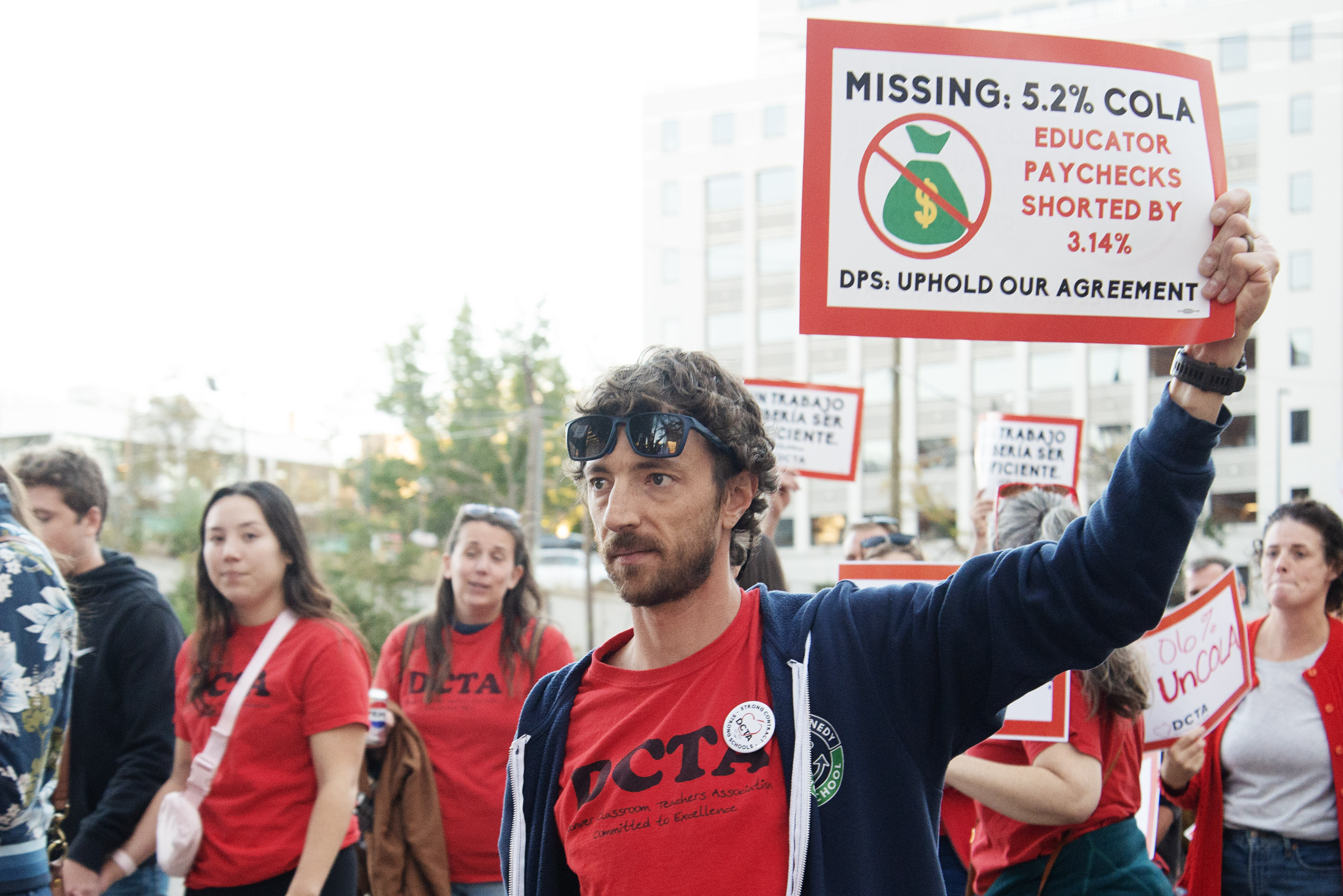 Taylor Roholt, a local educator, marches with members of Denver Teachers Classroom Association (DTCA) to the Denver Public Schools Emily Griffith Campus during a school board meeting to protest an agreed upon cost of living raise agreement from 2022 DPS has yet to enact on Monday, Oct. 21, 2024. 