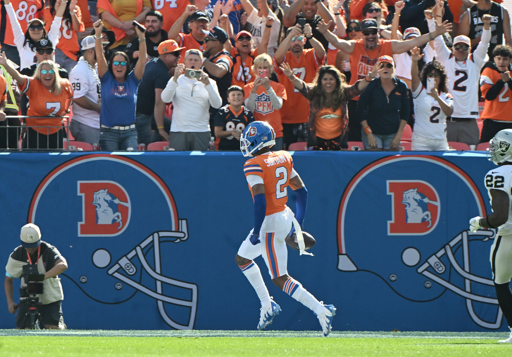 Broncos fans cheer wildly after Denver Broncos cornerback Pat Surtain II (2) goes into end zone after making a pick six during the second quarter of a game at Empower Field at Mile High on Sunday, Oct. 6, 2024. The Broncos won the game 34-18. (Jerilee Bennett, The Gazette)
