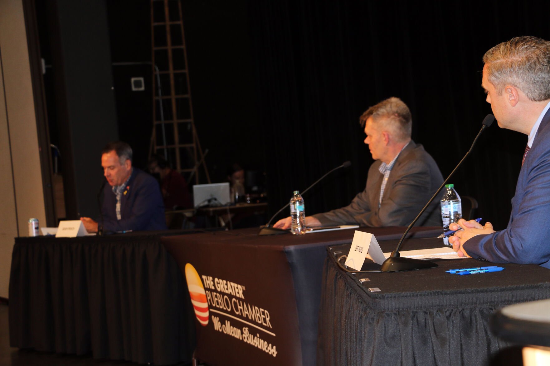 Debate moderator Ernest Luning of Colorado Politics and Republican candidate Jeff Hurd listens as Democratic candidate Adam Frisch responds to a question during a debate in Pueblo on Sept. 30. The two candidates are vying to represent the 3rd Congressional District.