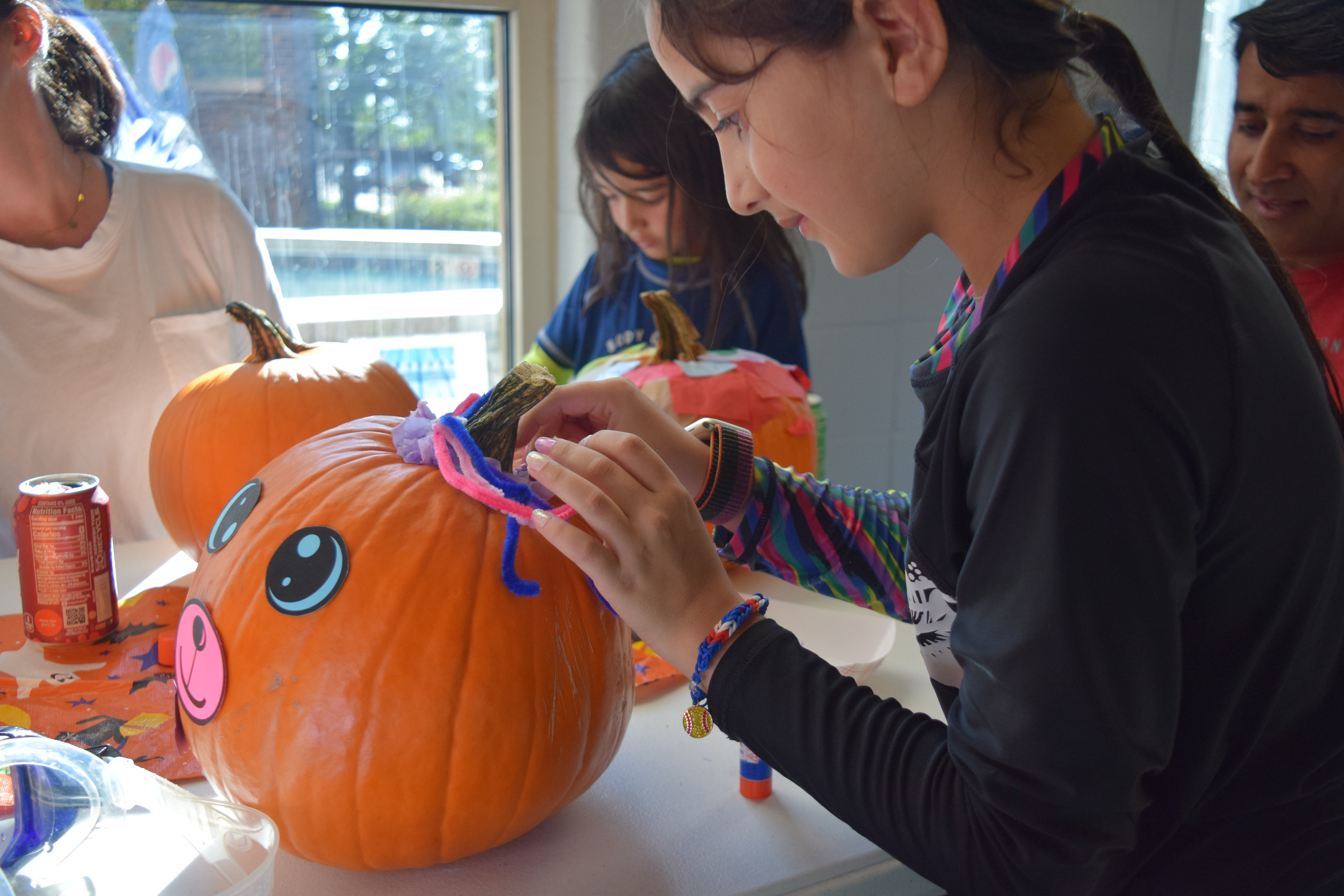 Eight-year-old Jocelyn Sandhu decorates her pumpkin using the arts and crafts provided by the South Suburban Parks and Recreation's art department at the Pumpkin Plunge on Saturday. (SageKelleyJefferson County Reportersage.kelley@denvergazette.comhttps://denvergazette.com/content/tncms/avatars/e/5f/457/e5f45740-2717-11ee-85b2-ab80f2d36252.5b966c1d2ce4987987665d57c237eda4.png)