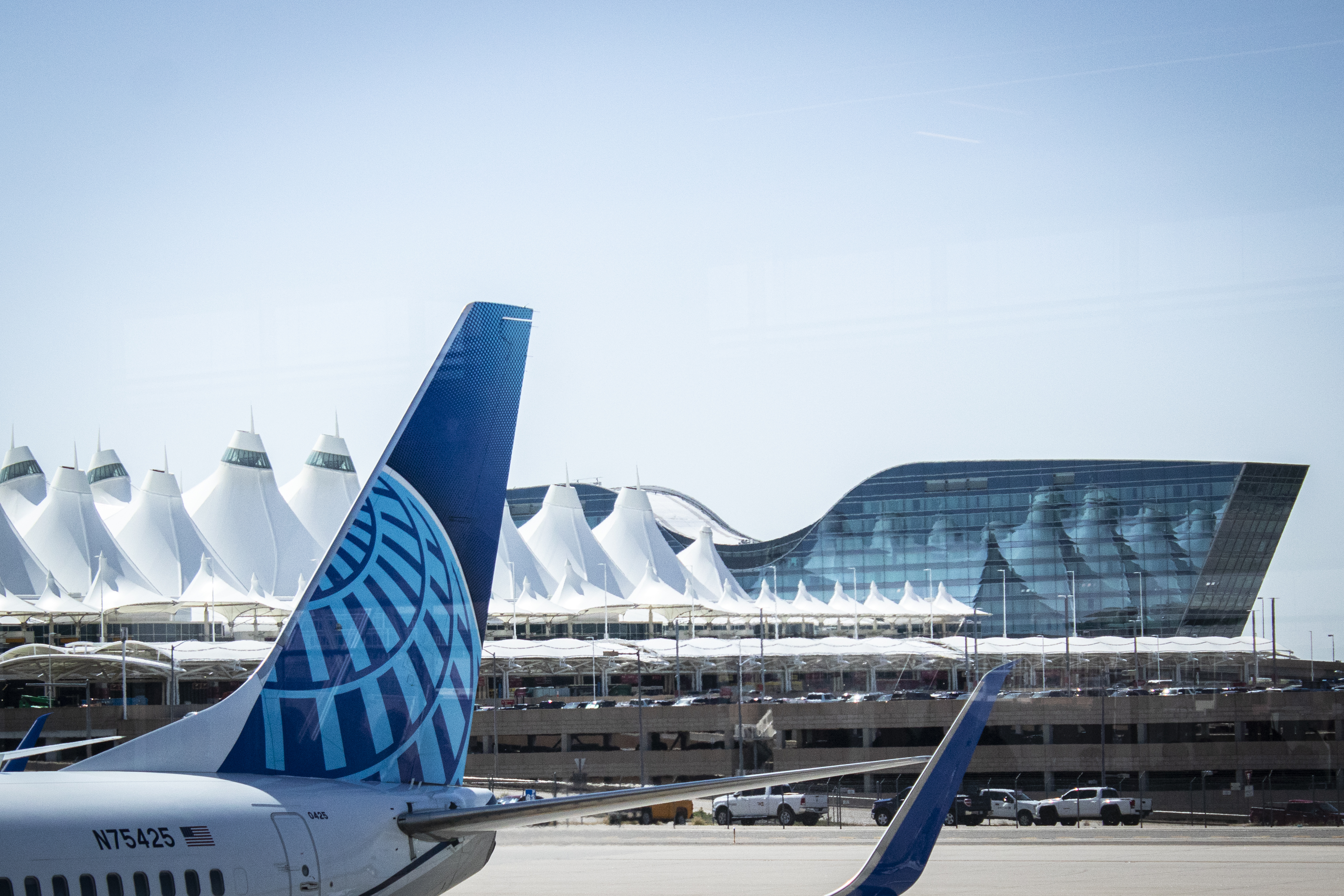 FILE PHOTO: A United plane awaits passengers at Denver International Airport in May 2024. The main terminal's iconic tent rooftops are made of