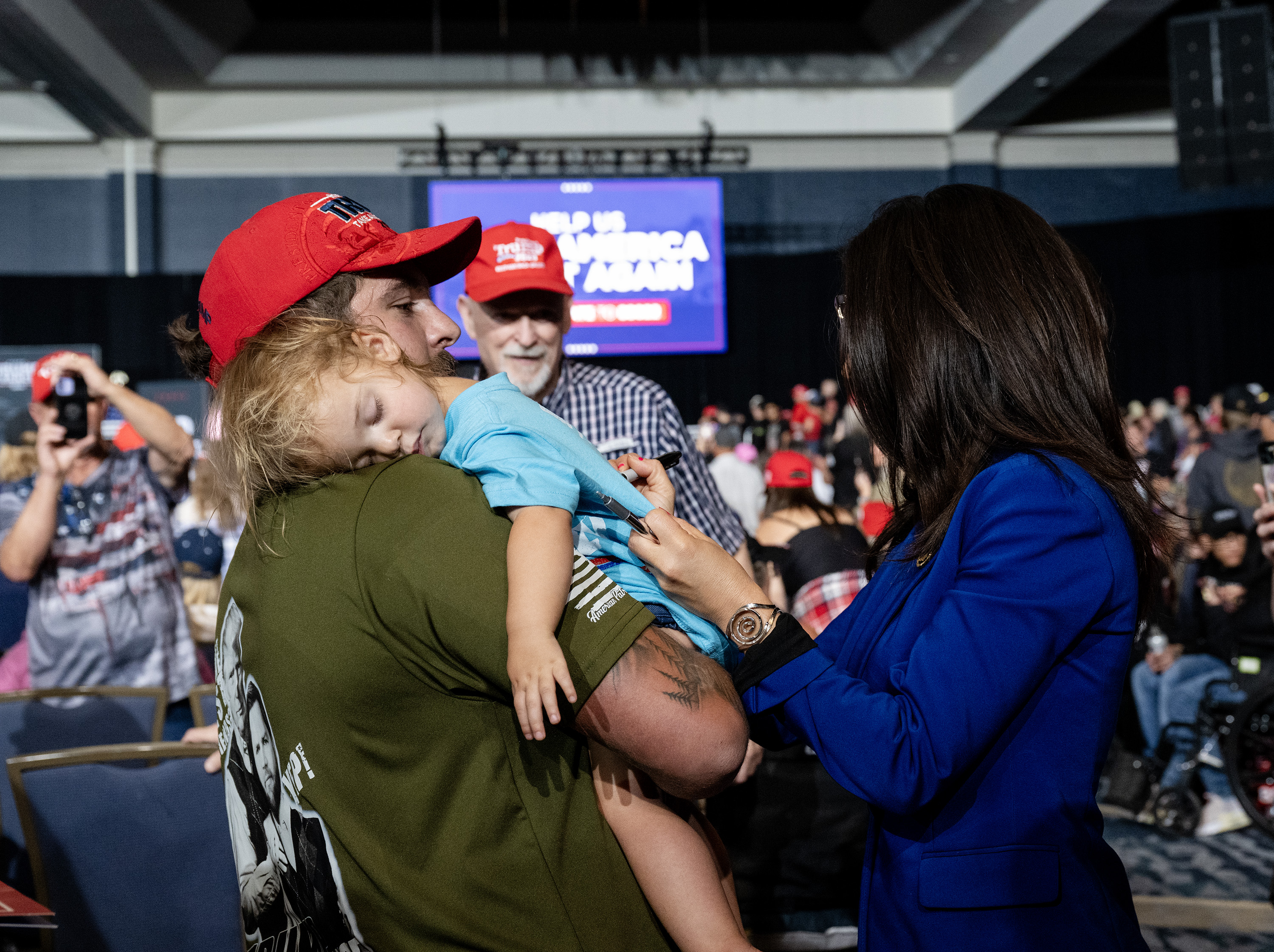 U.S. Rep. Lauren Boebert signs a sleeping child’s shirt during Republican nominee former President Donald Trump’s campaign rally at the Gaylord Rockies Resort and Convention Center, Friday, Oct. 11, 2024, in Aurora, Colo. (Parker Seibold, The Gazette) (Parker Seibold, The Gazette)