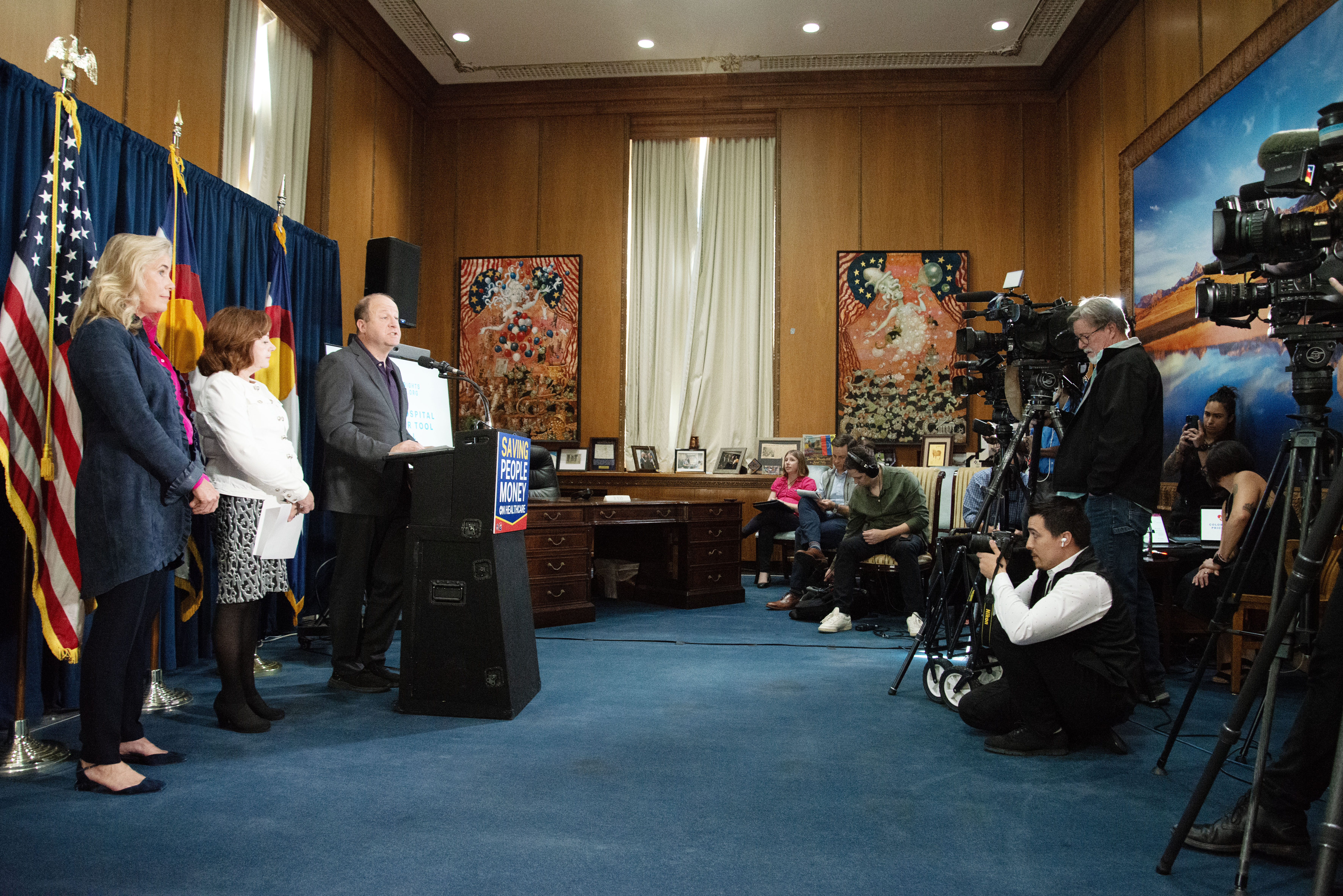 From left, Cynthia Fisher, founder of Patient Rights Advocate, Lt. Gov. Dianne Primavera and Gov. Jared Polis address members of the media about the launch of a new online database for Colorado healthcare patients to compare costs from various providers in the state created by the non-profit, Patient Rights Advocate, from the Colorado State Capitol on Tuesday, Oct. 22, 2024. Costs of procedures and treatment can vary as much as, 