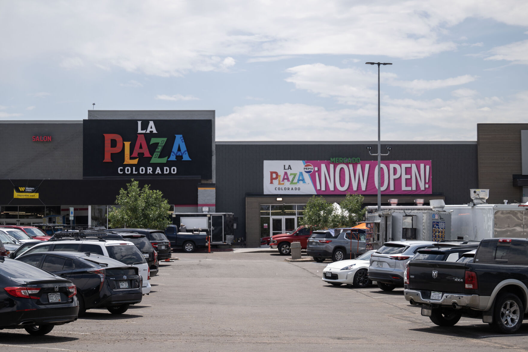People eat lunch from food trucks outside the newly opened La Plaza in Denver on Friday, July 19, 2024. (Stephen Swofford, Denver Gazette) (StephenSwoffordPhotographerstephen.swofford@gazette.comhttps://secure.gravatar.com/avatar/1ddcaf11c5d70eaa58546ddc4e038687?d=mm&r=g)