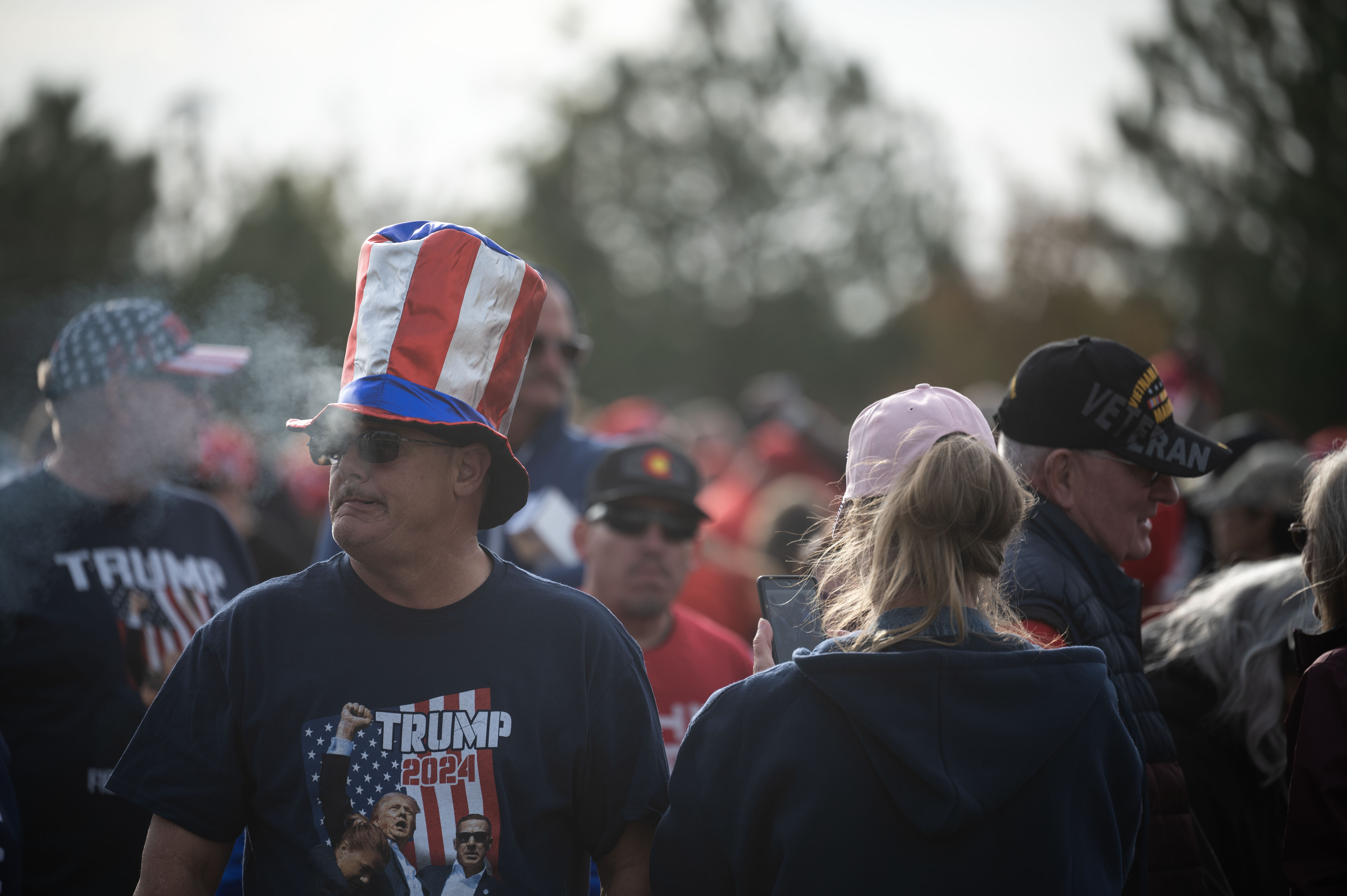 Bret Fox smokes a cigarette as he waits to be let into the Gaylord Rockies Resort and Convention Center in Aurora before the start of a trump rally on Friday, Oct. 11, 2024. (Stephen Swofford, Denver Gazette) (Stephen Swofford Denver Gazette)