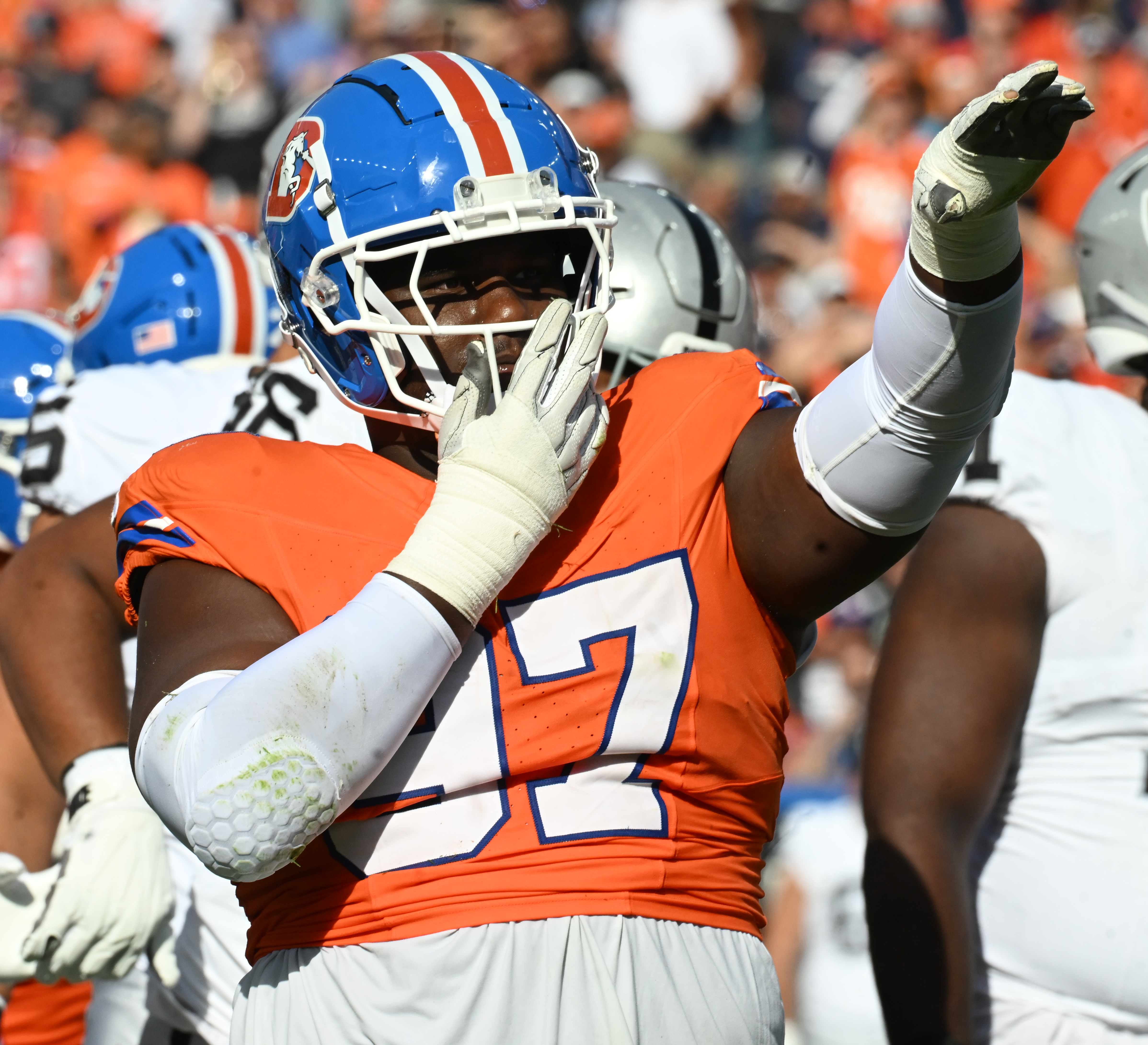 Denver Broncos defensive tackle Malcolm Roach (97) waves to the fans after making a play during a game against the Raiders at Empower Field at Mile High on Oct. 6, 2024. (Christian Murdoch, The Denver Gazette)
