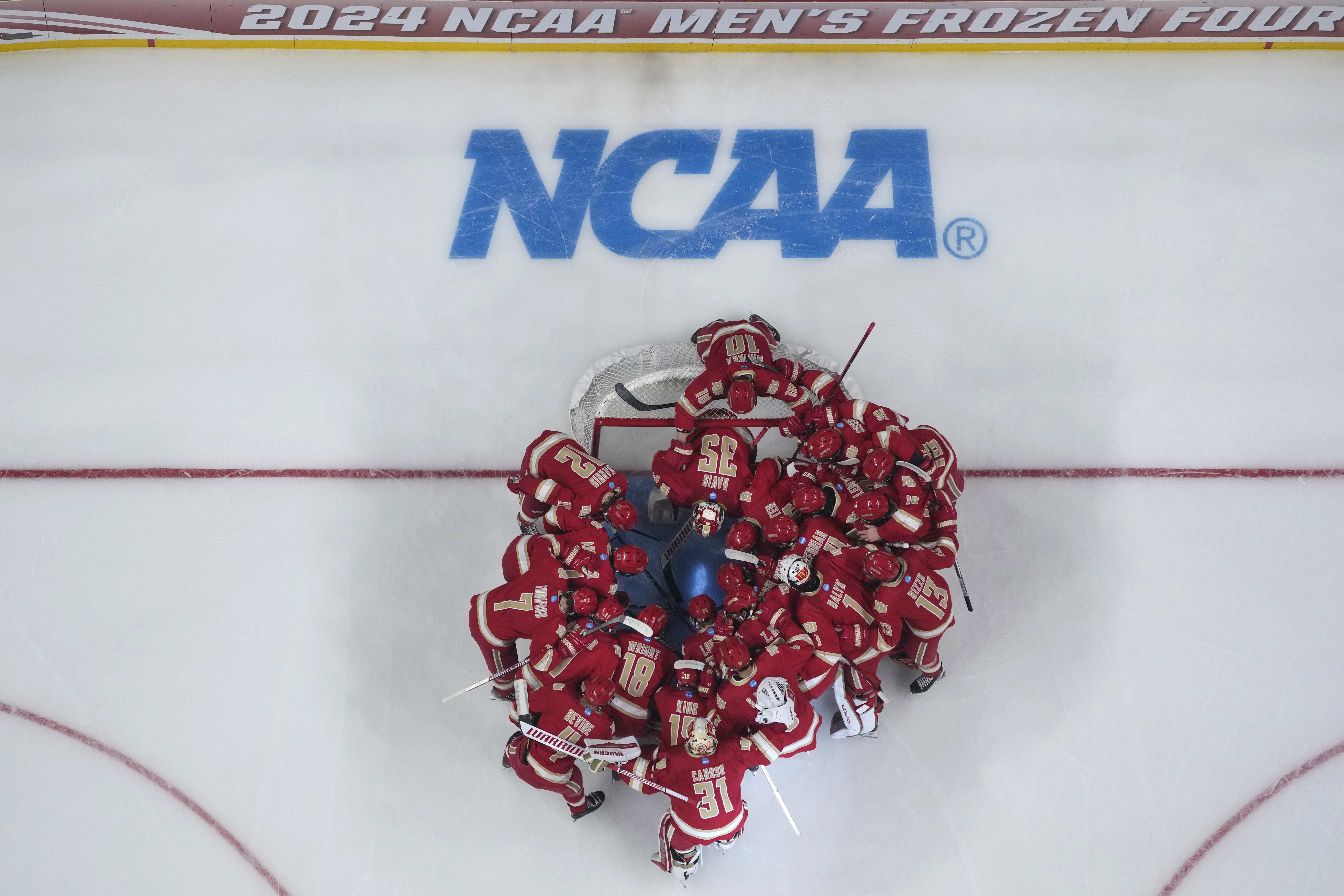 Denver players huddle before a Frozen Four semifinal against Boston University in the men's NCAA college hockey tournament Thursday, April 11, 2024, in St. Paul, Minn. (AP Photo/Abbie Parr) (Abbie Parr)