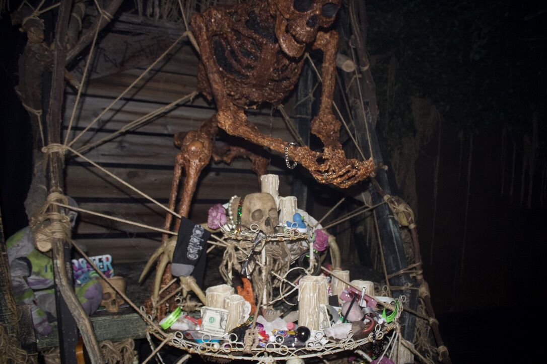 A skeleton prop holds sacrifices of those participating in 