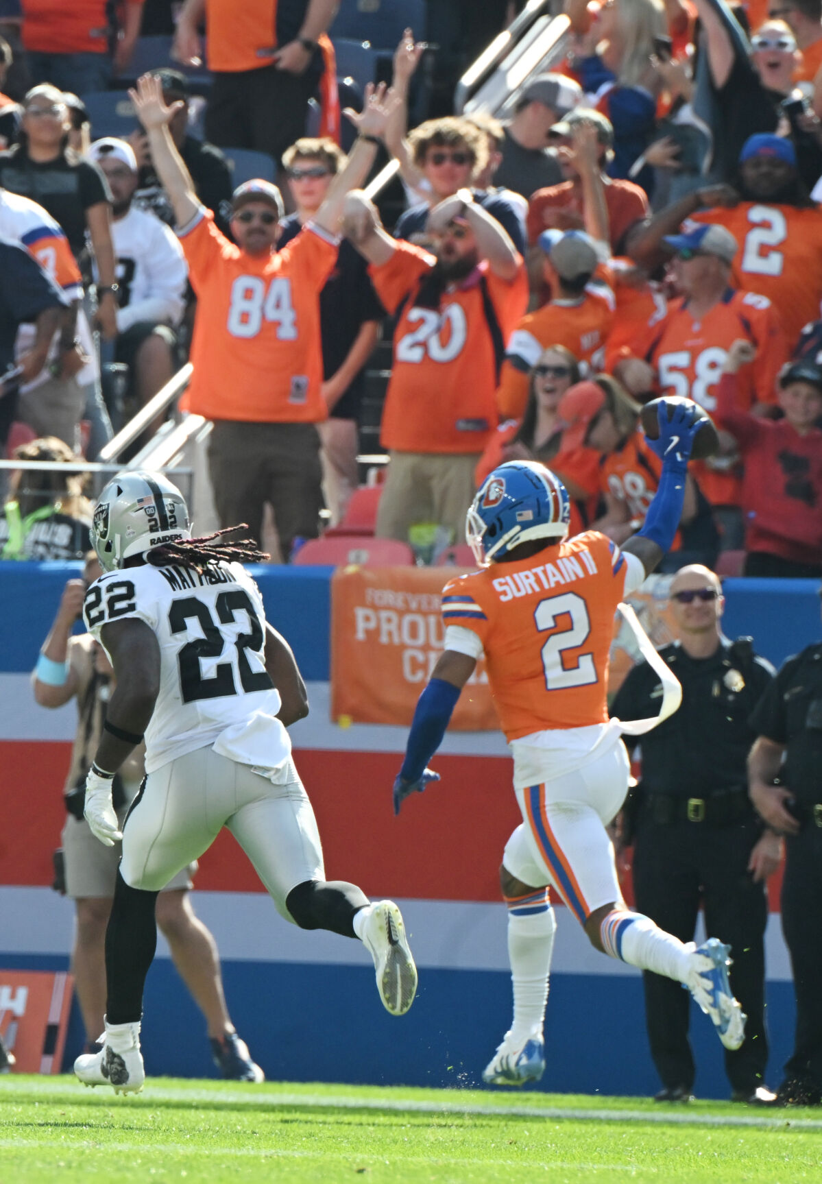 Denver Broncos cornerback Pat Surtain II (2) holds the ball up as he heads for the end zone after making a pick six during the second quarter of a game at Empower Field at Mile High on Sunday, Oct. 6, 2024. The Broncos won the game 34-18. (Jerilee Bennett The Gazette)