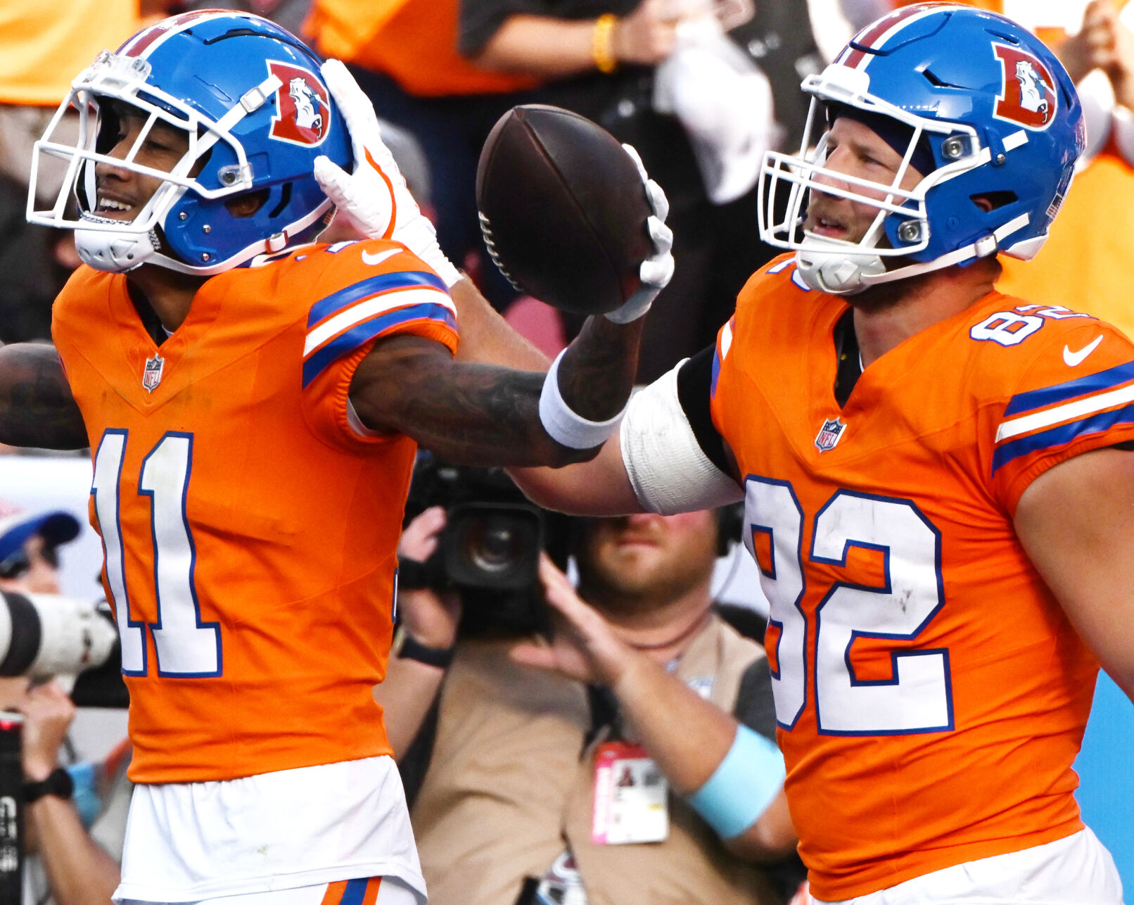 Denver Broncos wide receiver Josh Reynolds (11) celebrates with Denver Broncos tight end Adam Trautman (82) after Reynolds got a touchdown pass during the fourth quarter of a game at Empower Field at Mile High on Sunday, Oct. 6, 2024. The Broncos won the game 34-18. (Jerilee Bennett The Gazette)