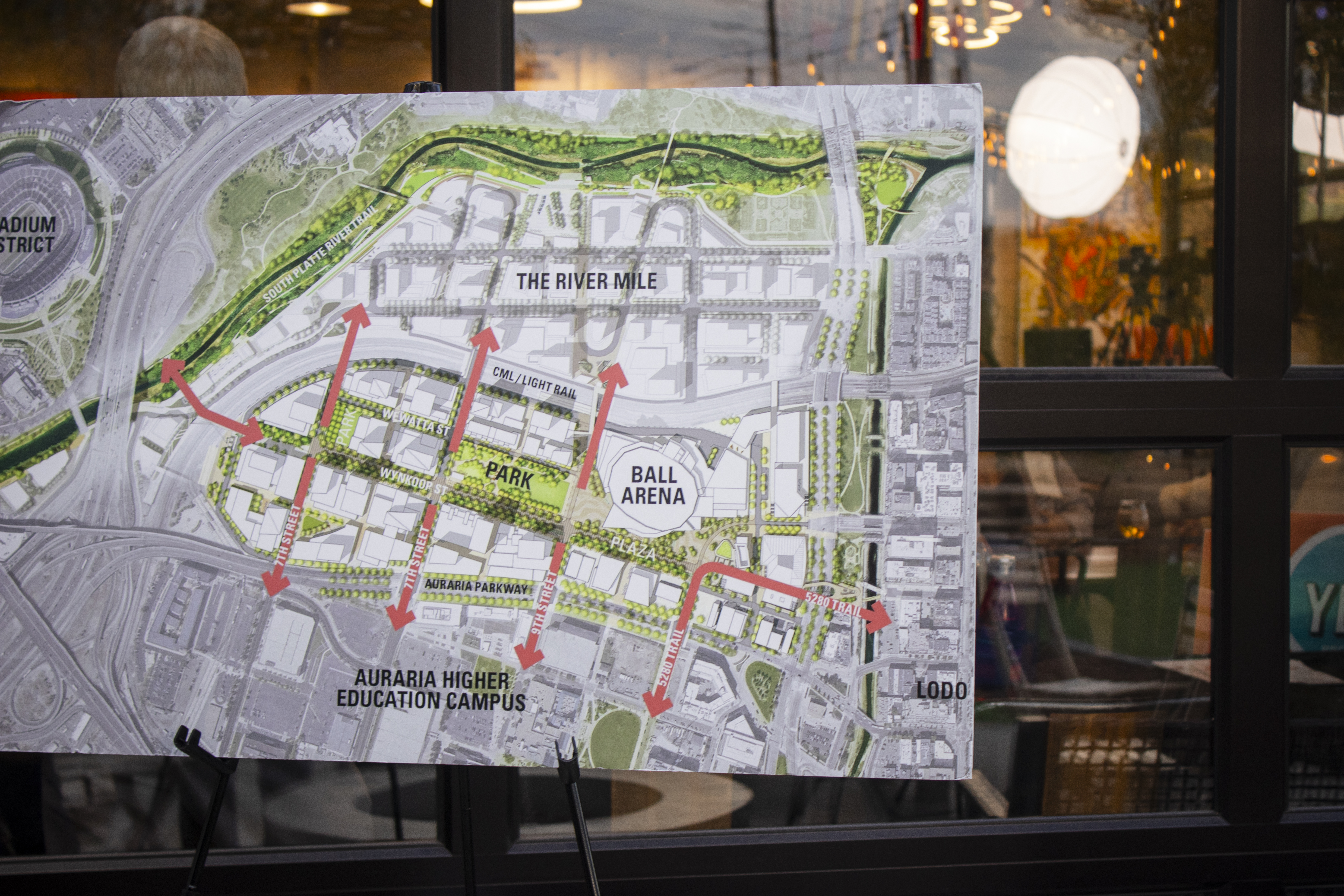 A poster showing a map of the Ball Arena and River Mile development is on display at Raíces Brewing Company on Wednesday, Oct. 16, 2024 (Bernadette Berdychowski / The Denver Gazette)
