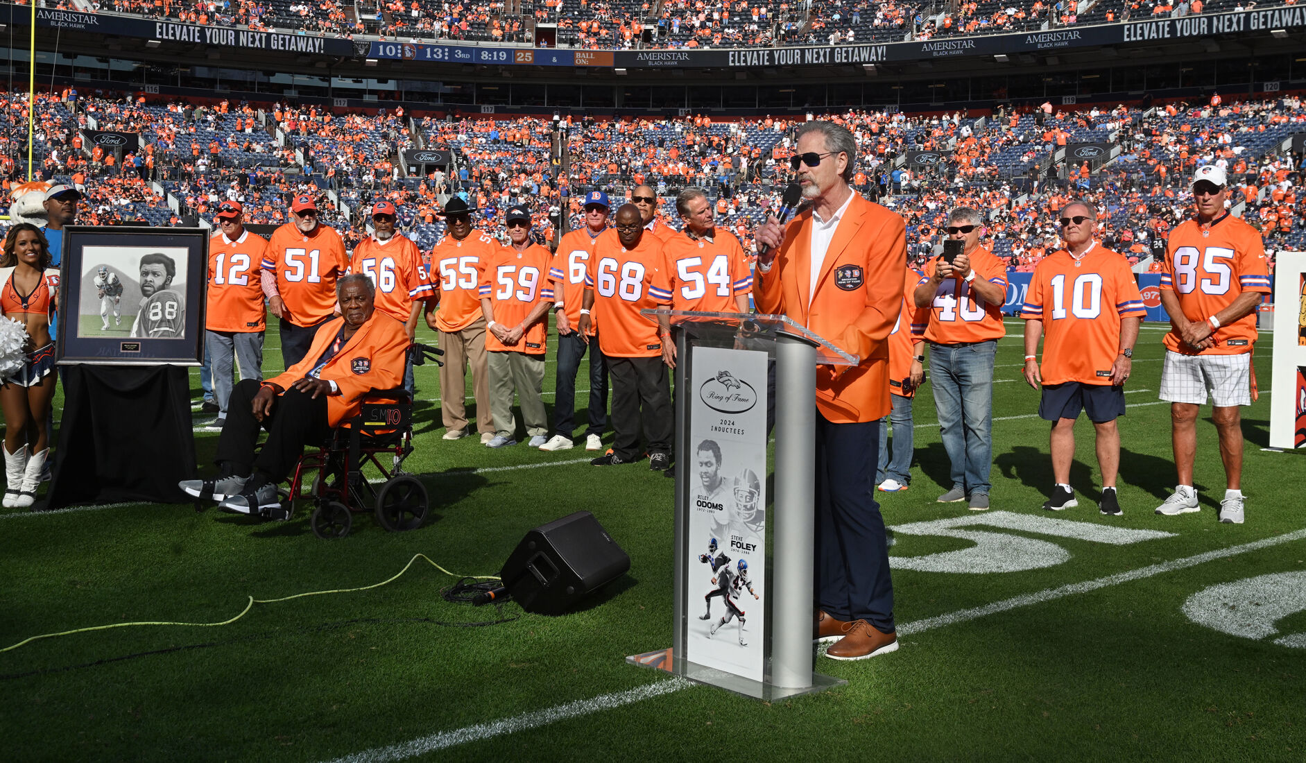 Many members of the ’77 Broncos team, the first Broncos team to go to the Super Bowl, were on hand to see two of their own to be added to the Broncos Ring of Fame. Steve Foley speaks to the crowd about how honored he is to be included in the Ring of Fame at Empower Field at Mile High on Sunday, Oct. 6, 2024. (Jerilee Bennett, The Gazette)