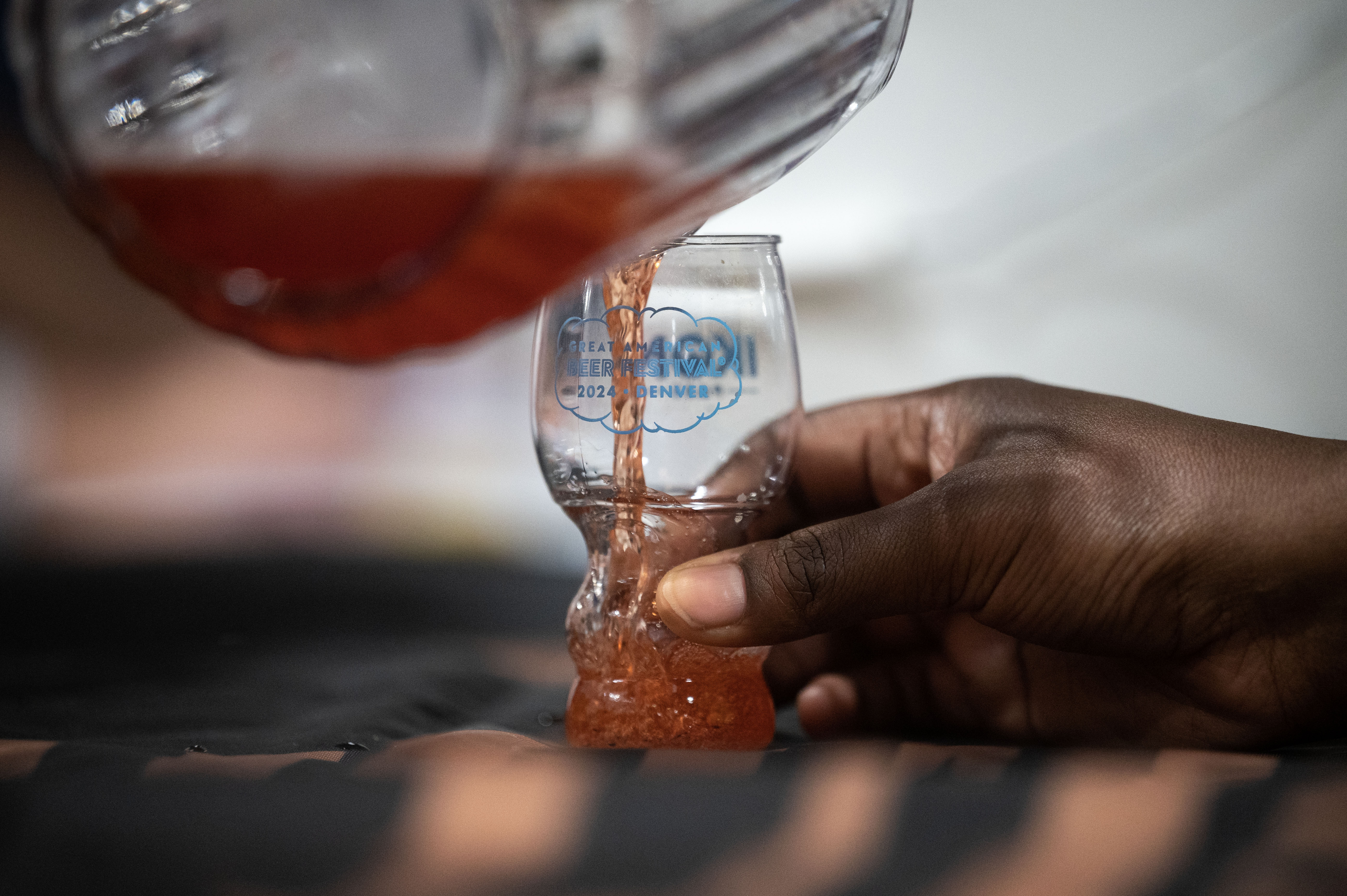 Rich Reinke, known as “Brewmaster Rich”, pours a sample from Riverstone Brewing on the opening night of the Great American Beer Festival on Thursday, Oct. 10, 2024 (Stephen Swofford, Denver Gazette) (Stephen Swofford Denver Gazette)