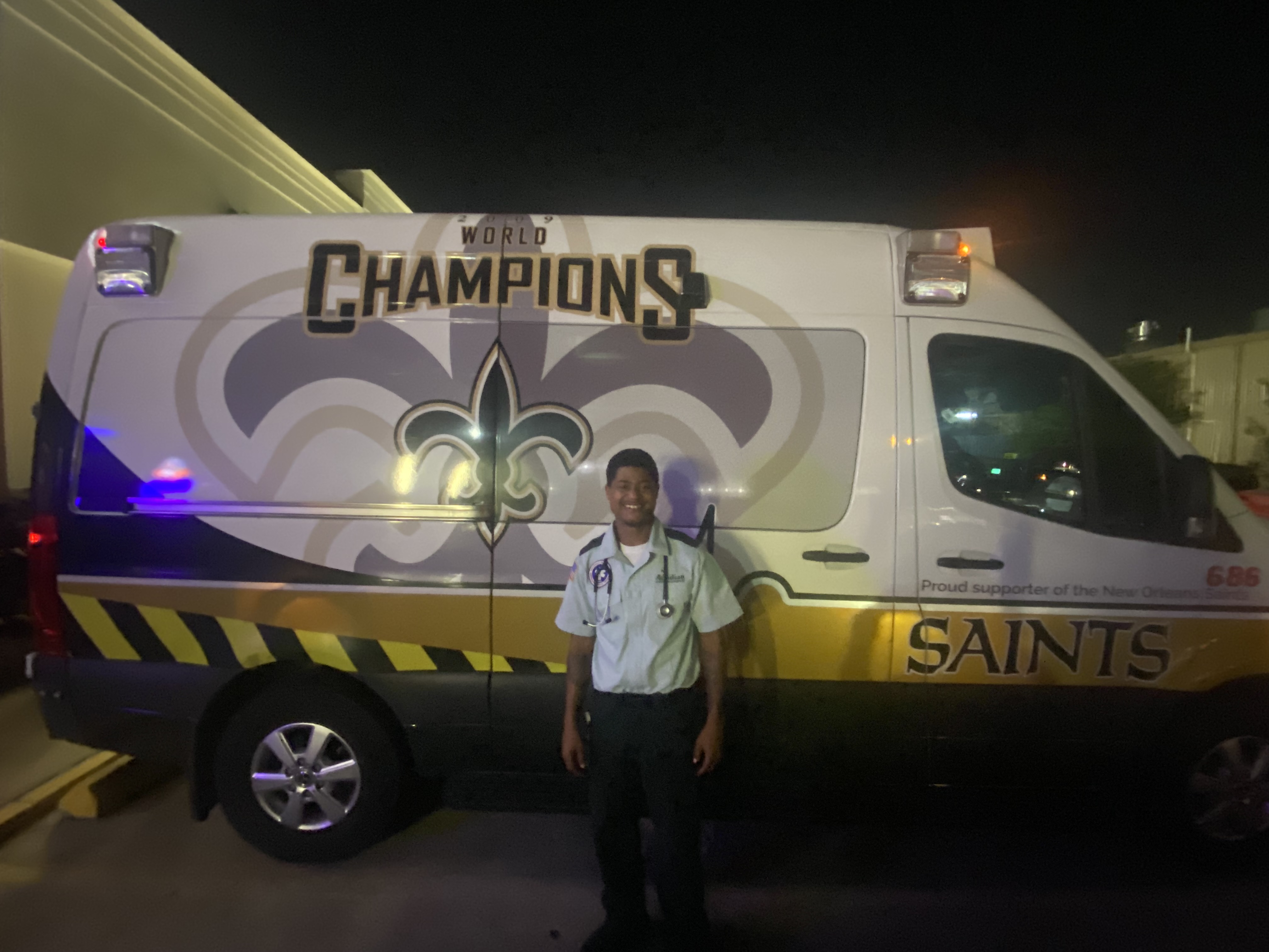 Kenneth Williams, an emergency medical technician for Acadian Ambulance Service in front of his vehicle in Kenner, La., on Oct. 15, 2024. Acadian serves the New Orleans area and Williams said about one-third of its 250 ambulances are decorated in Saints colors and pay homage to their Super Bowl win in the 2009 season under Sean Payton, now head coach of the Broncos. Photo by Chris Tomasson/Denver Gazette.