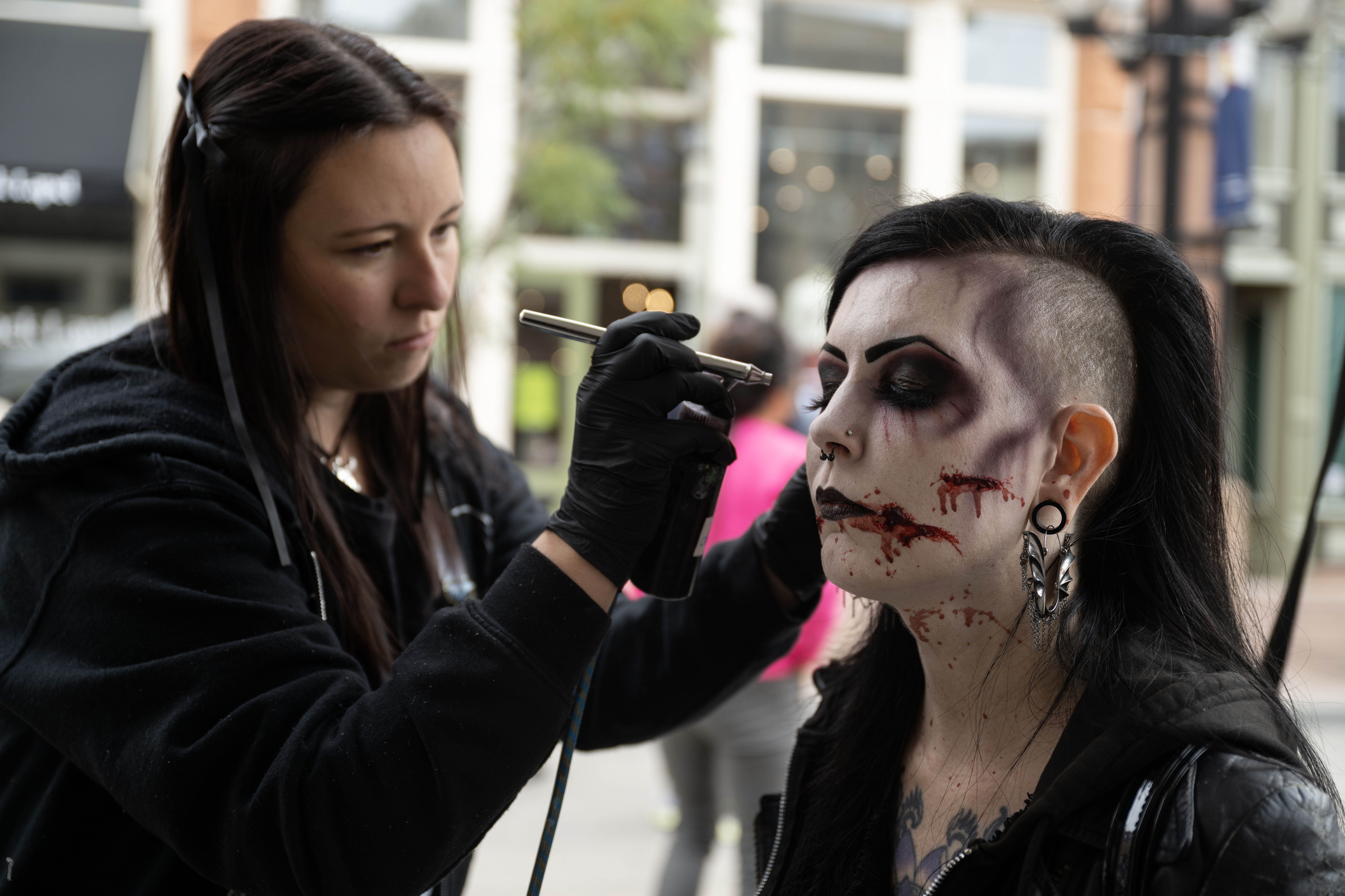 Marie Sheldon, left, applies zombie makeup to Vanessa Von Thun during the Zombie Crawl in Larimer Square on Saturday, Oct. 19, 2024. (Stephen Swofford, Denver Gazette) (StephenSwoffordPhotographerstephen.swofford@gazette.comhttps://secure.gravatar.com/avatar/1ddcaf11c5d70eaa58546ddc4e038687?d=mm&r=g)