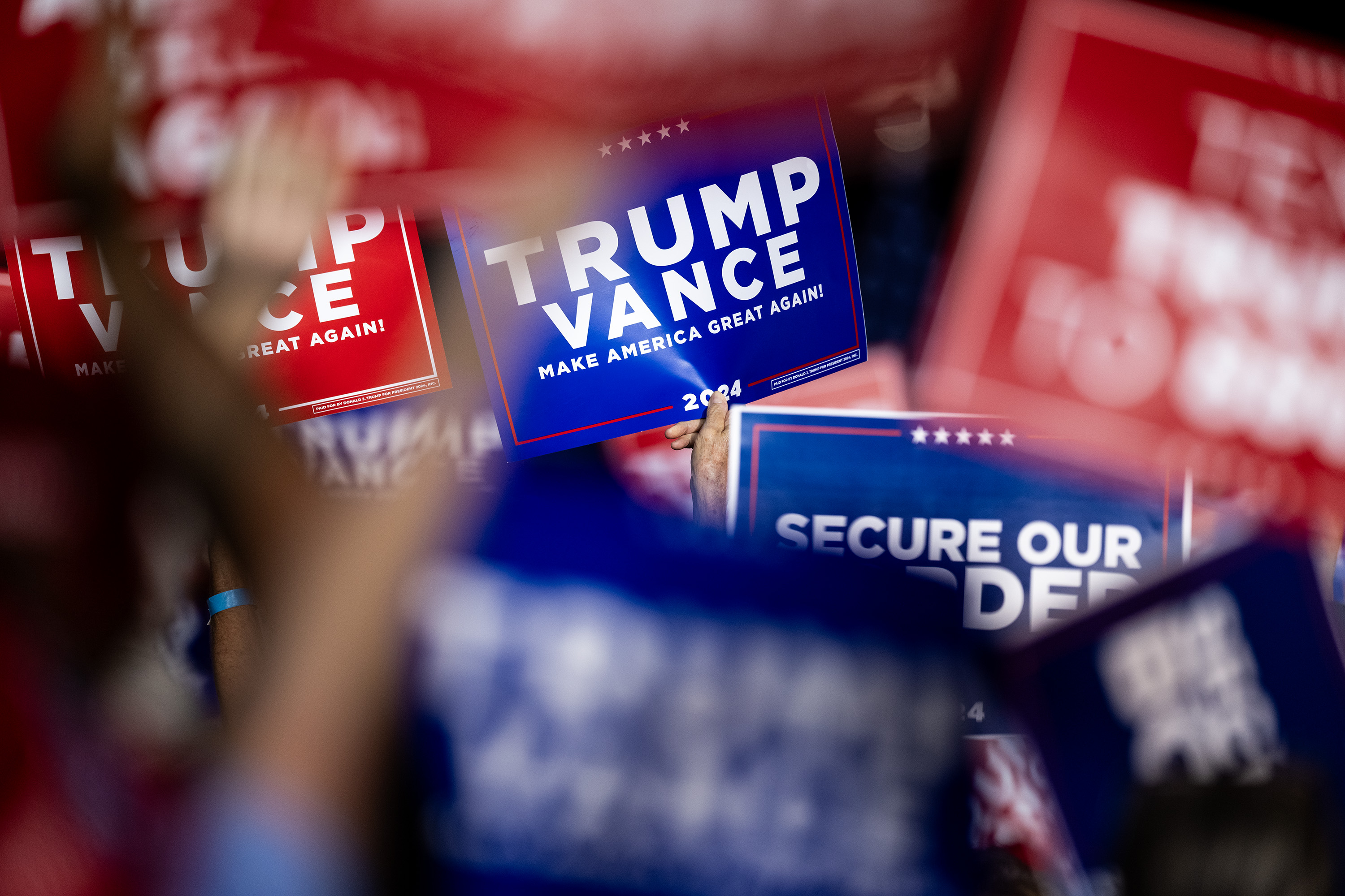 People hold up signs and cheer as Republican presidential nominee former President Donald Trump makes remarks during a campaign rally at the Gaylord Rockies Resort and Convention Center, Friday, Oct. 11, 2024, in Aurora, Colo. (Parker Seibold, The Gazette) (Parker Seibold, The Gazette)