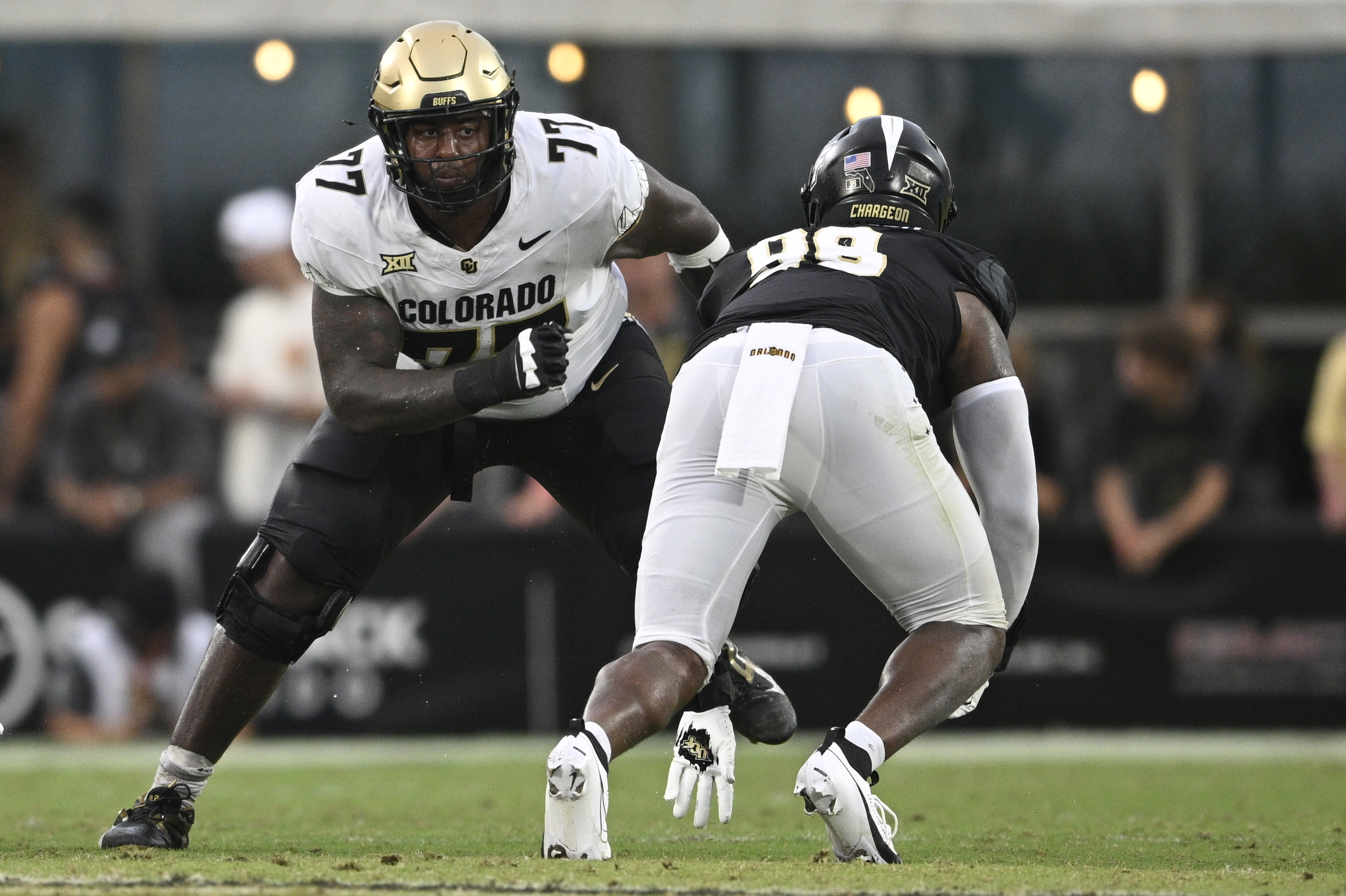 Colorado offensive tackle Jordan Seaton (77) sets up to block against Central Florida defensive end Jamaal Johnson (99) during the second half of an NCAA football game, Sept. 28, 2024, in Orlando, Fla. (Phelan M. Ebenhack)