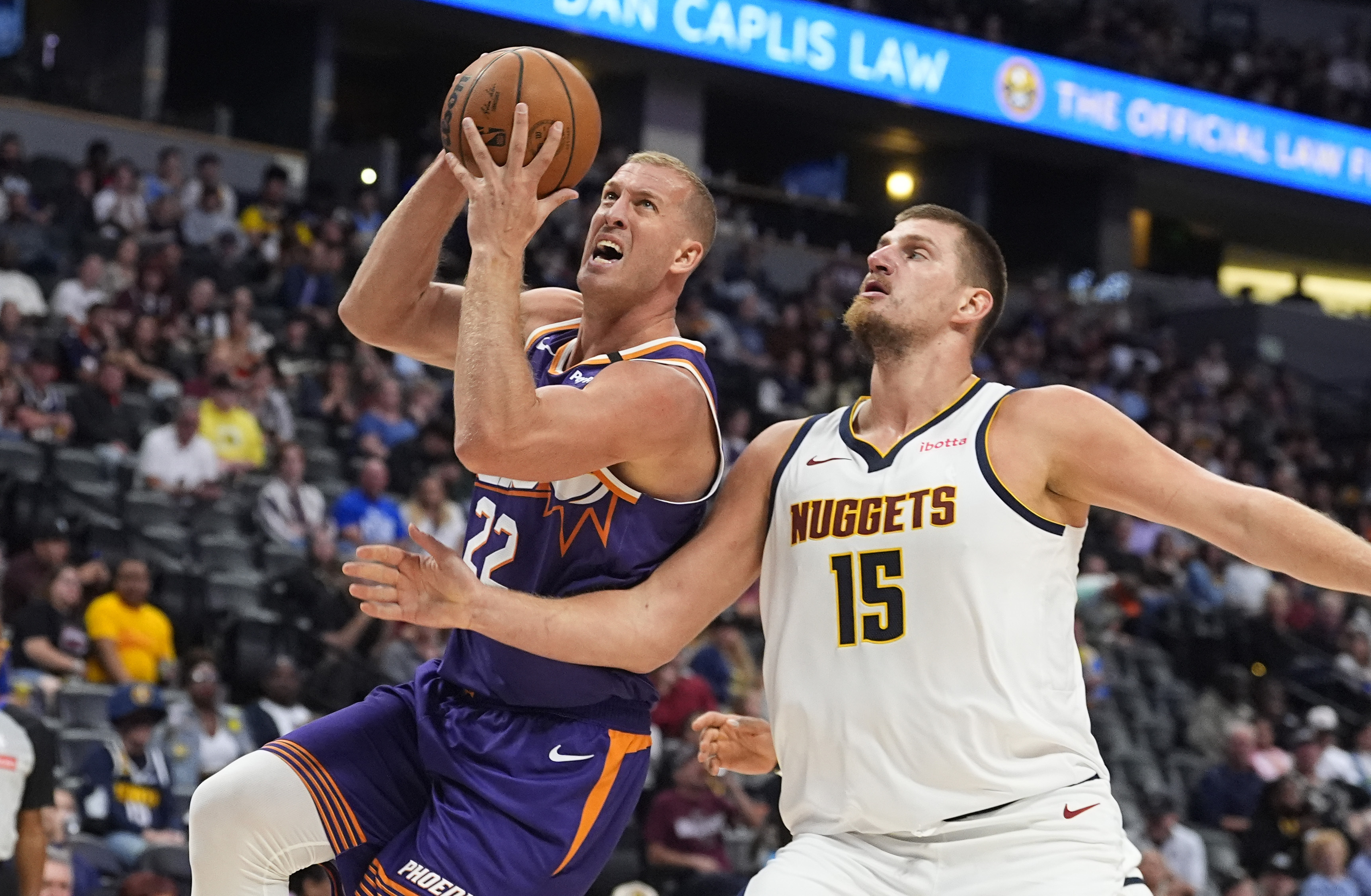 Phoenix Suns center Mason Plumlee, left, drives to the rim past Denver Nuggets center Nikola Jokic in the second half of an NBA preseason game Sunday, Oct. 13, 2024, in Denver. (AP Photo/David Zalubowski) (David Zalubowski)