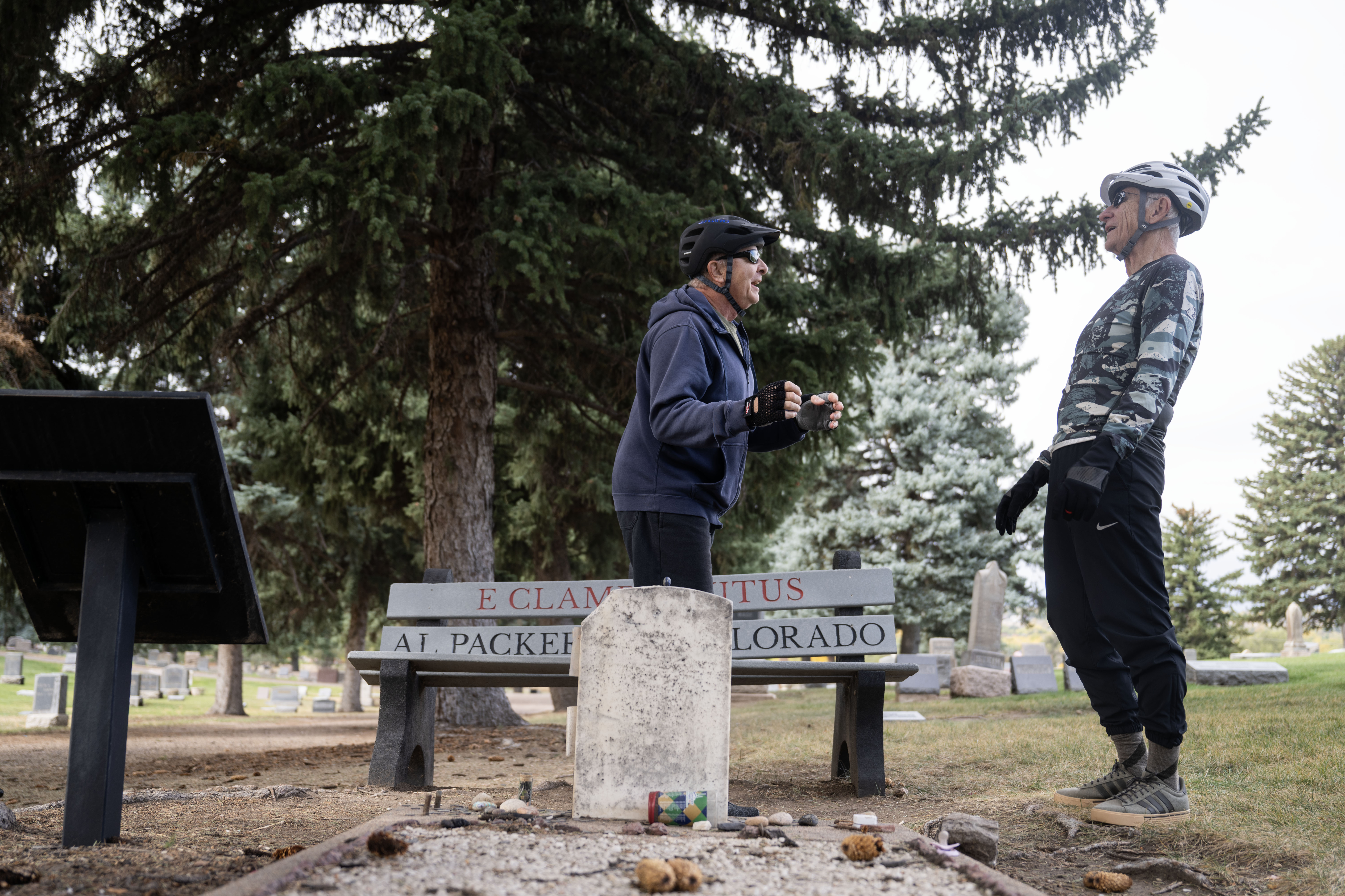 Pat McManis, left, and Mike Milner, visit the headstone of Alfred Packer. The only man in US History to be convicted of a crime related to Cannibalism. His headstone lies in the Littleton Cemetery, where people leave coins and trinkets such as silverware, painted stones, and occasionally chicken bones. (Stephen Swofford, Denver Gazette) (Stephen Swofford Denver Gazette)