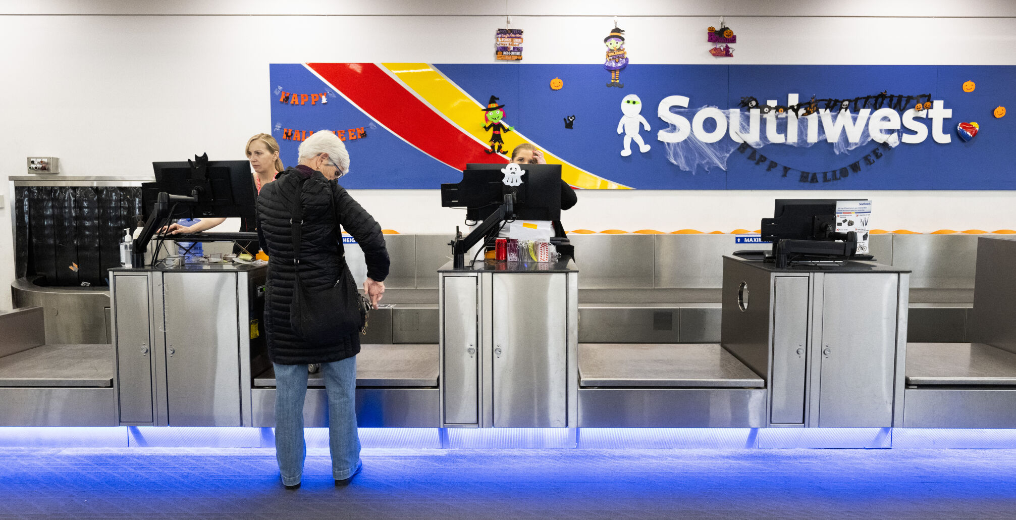 Customer service agents Kat Scott, left, and LisaMarie Andrews help a traveler check in at the Southwest Airlines counter Wednesday, Oct. 30, 2024, at the Colorado Springs Airport. Southwest Airlines announced a non-stop flight to Cancun, Mexico, from Colorado Springs that will begin in June of 2025. It'll be the first international flight out of the Colorado Springs Airport. (The Gazette, Christian Murdock) (Christian Murdock)