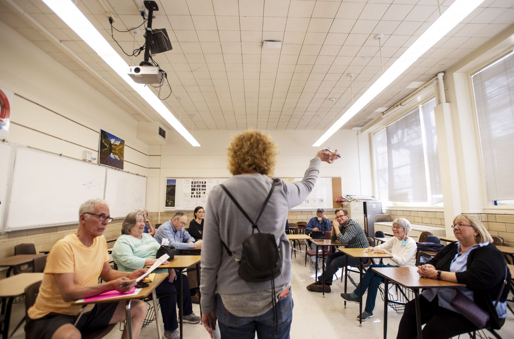 Democrat Rata Clarke, center, leads Precinct 172 to start voting during precinct caucuses in 2020 at Palmer High School. (file photos by the gazette)