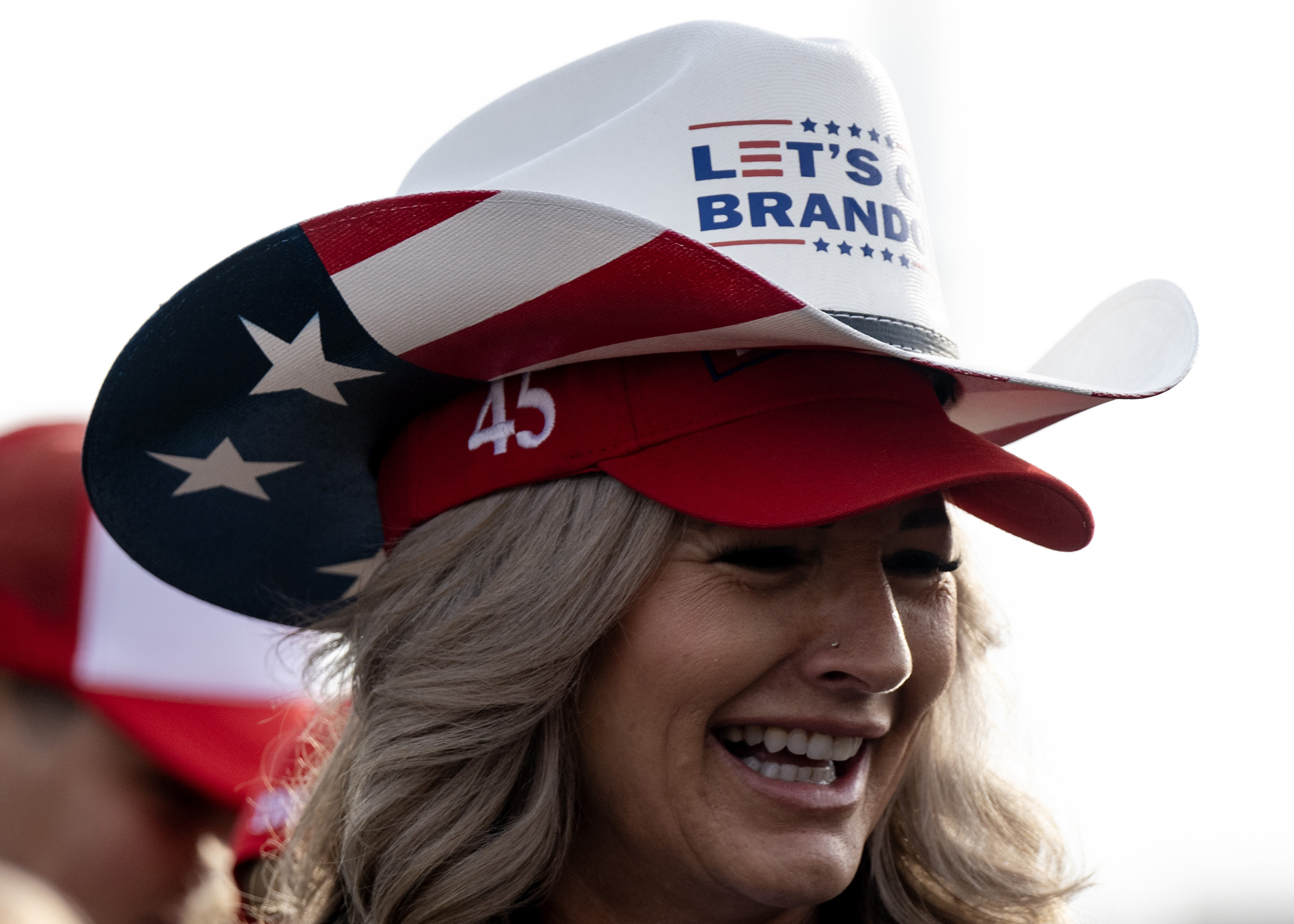 Dana Bonham, of Douglas County, stacks Trump hats at a campaign rally at the Gaylord Rockies Resort and Convention Center, Friday, Oct. 11, 2024, in Aurora, Colo. (Parker Seibold, The Gazette) (Parker Seibold, The Gazette)