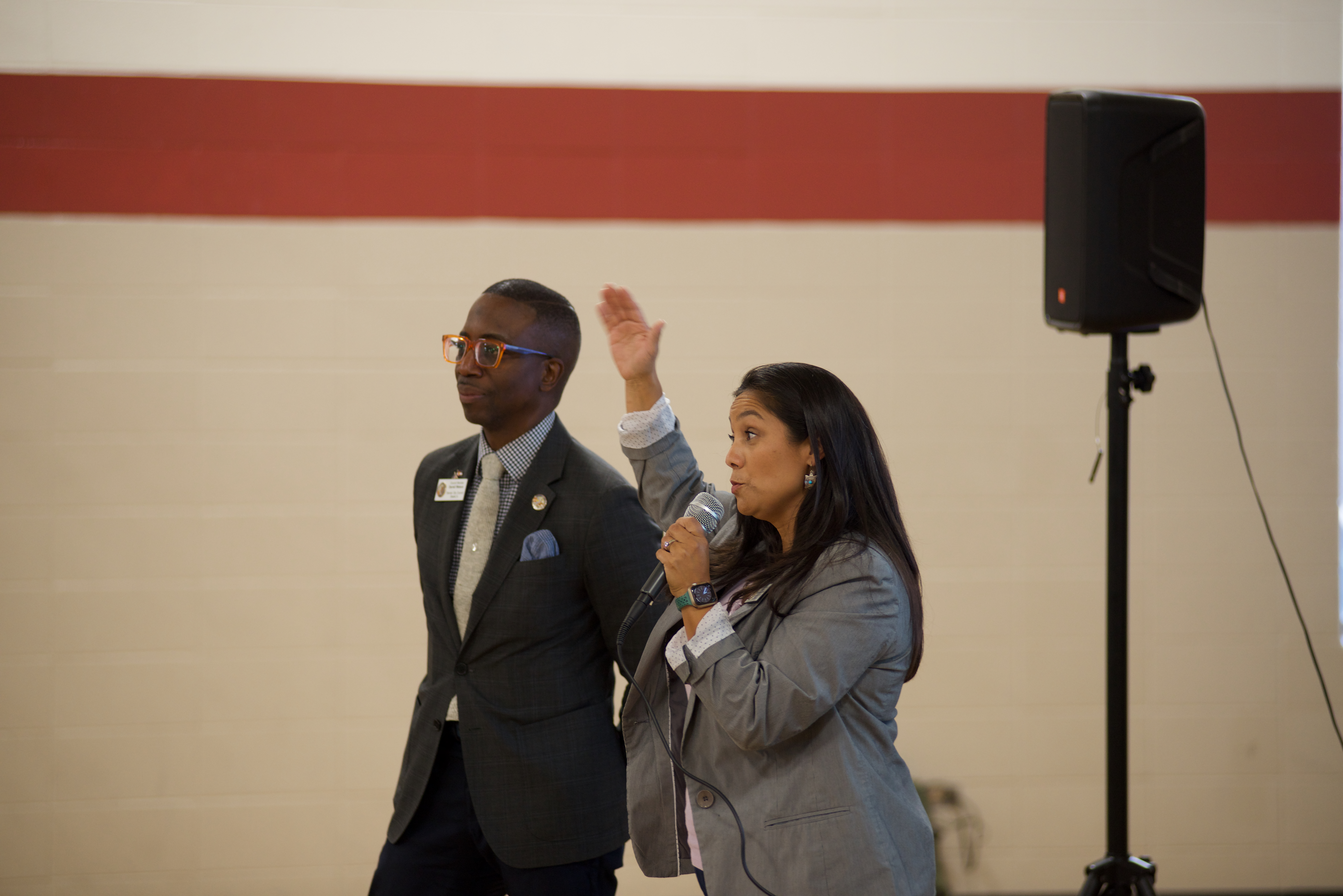 Councilmembers Darrell Watson and Serena Gonzales-Gutierrez speak to a crowd at Glenarm Recreation Center ahead of a community conversation on 