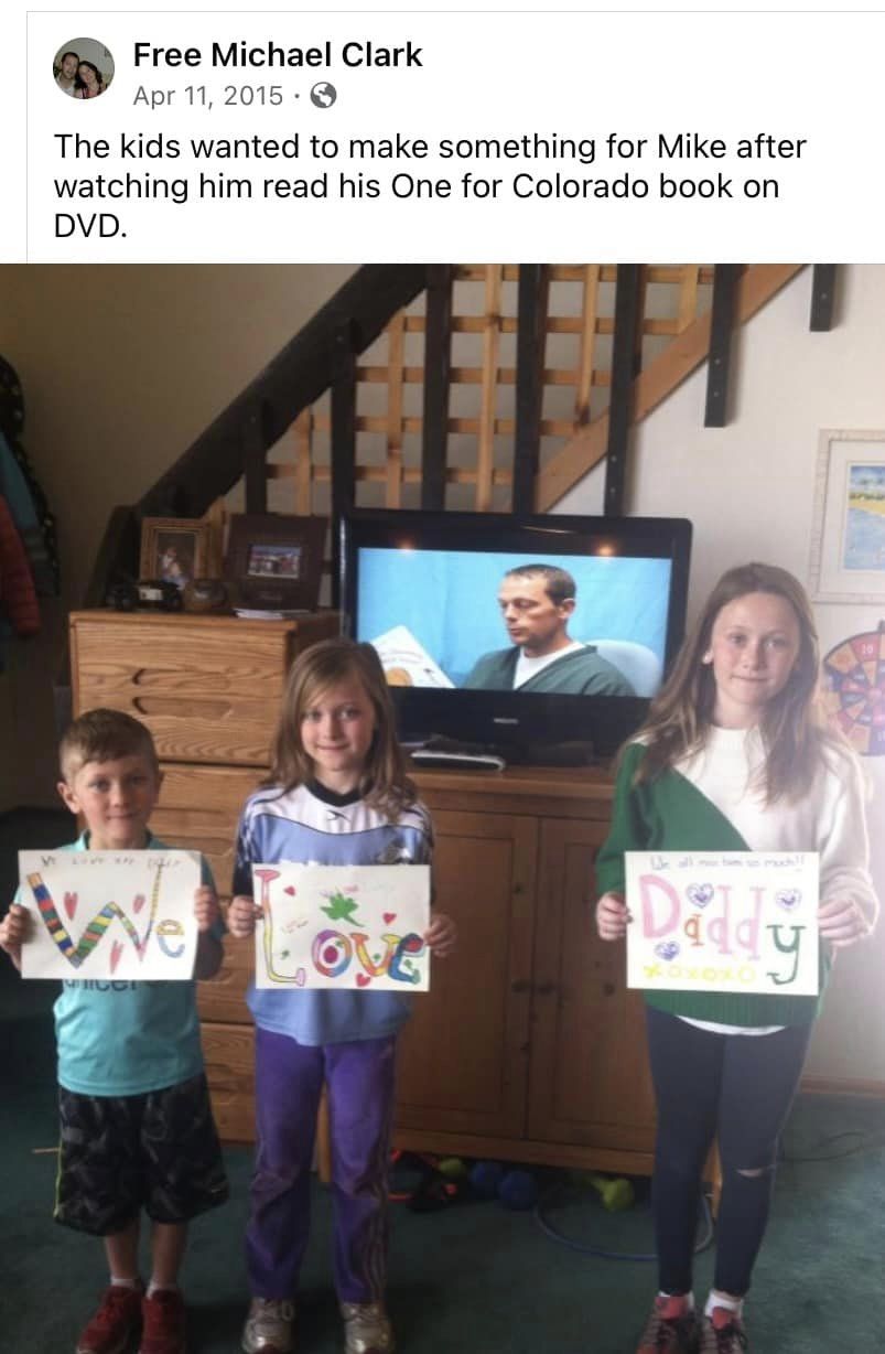 In 2015, Michael Clark's children, Kiernan (left), Kylie and Mikaela, displayed a message to their father in prison after watching a video of him reading to them. (Provided by the family of Michael Clark)